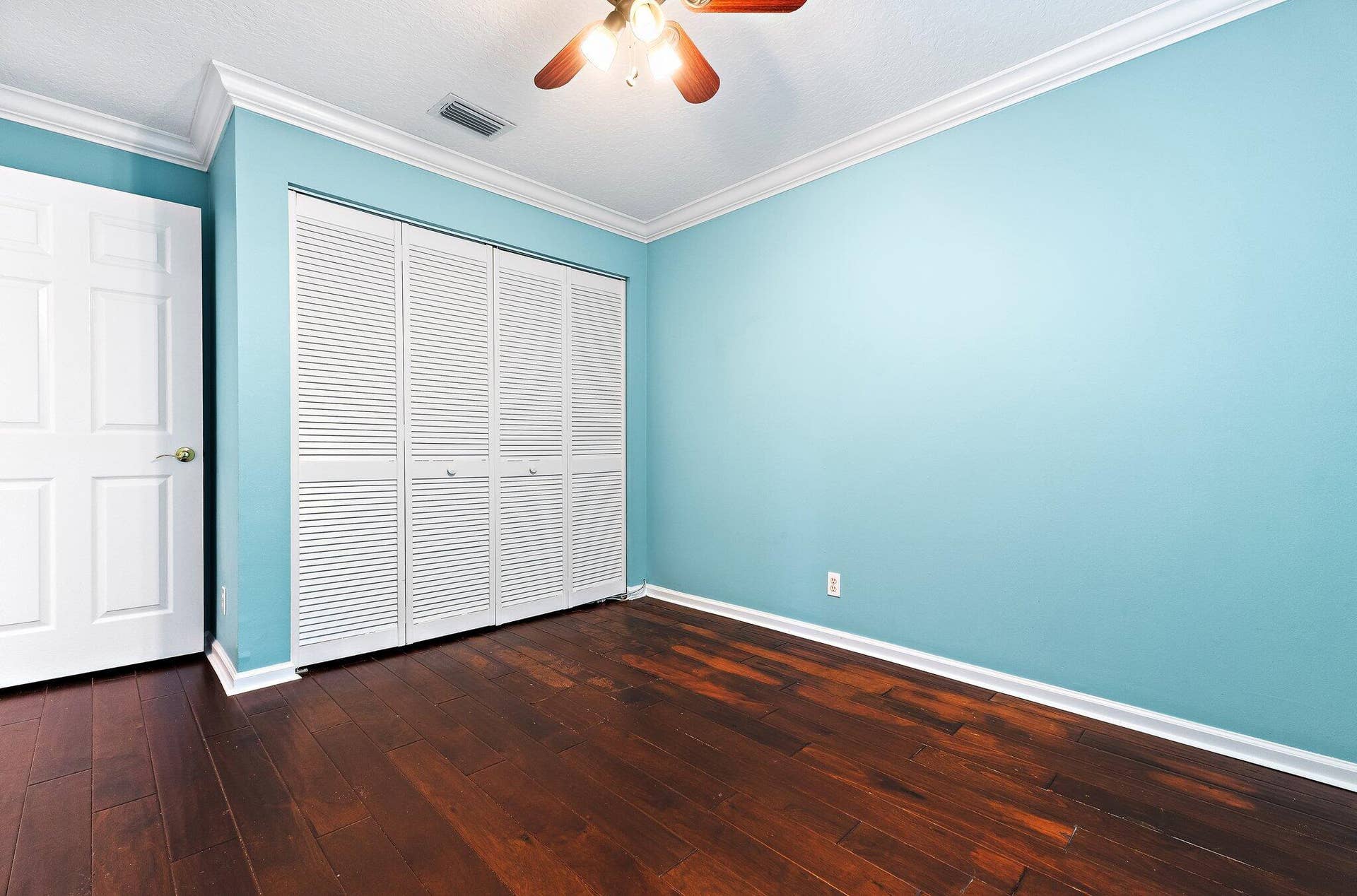 6037 Foster Street, Jupiter, FL 33458 Guest bedroom with wood floors and a double closet.