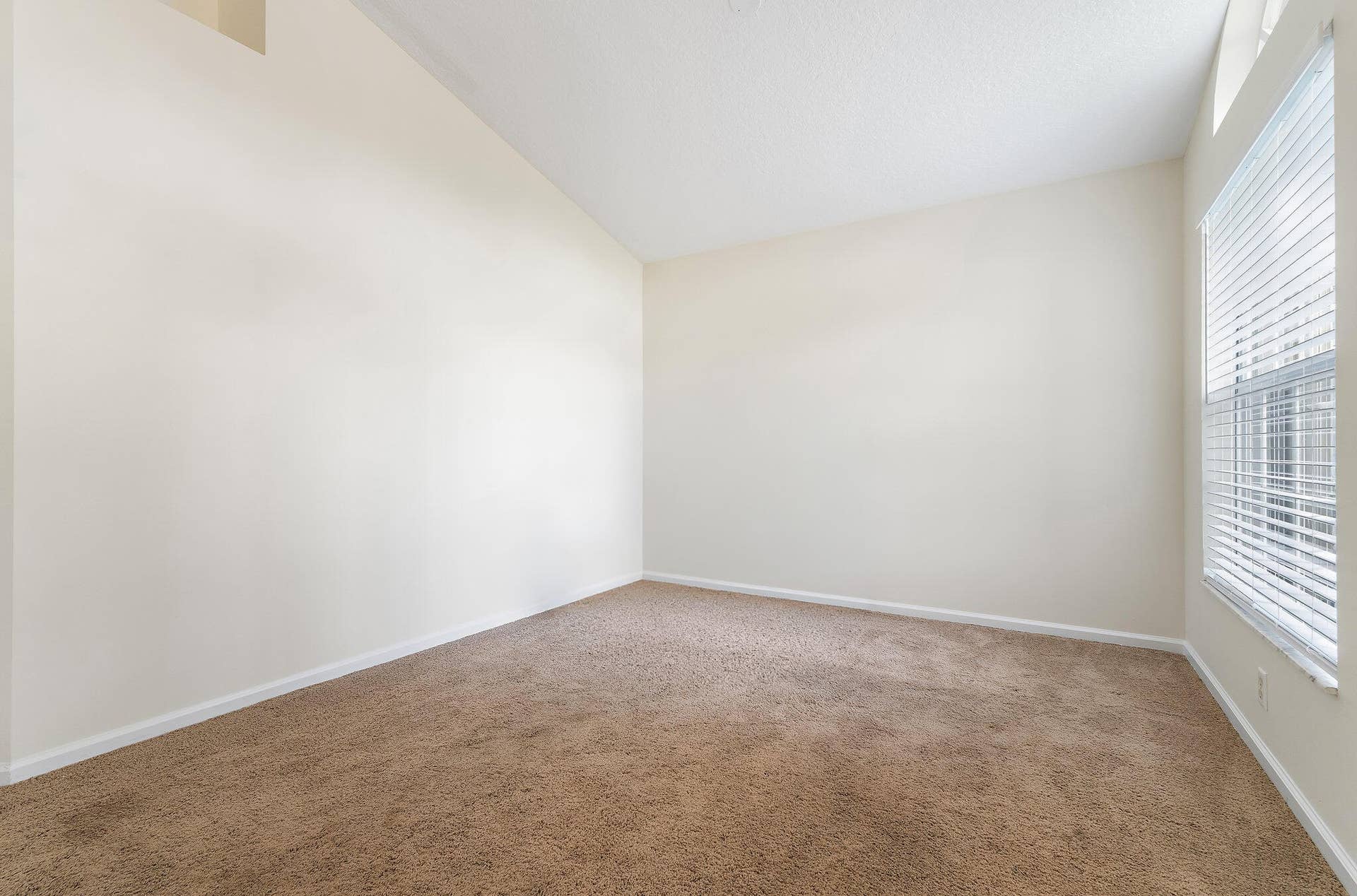 6037 Foster Street, Jupiter, FL 33458 Living room with high ceilings and natural light.