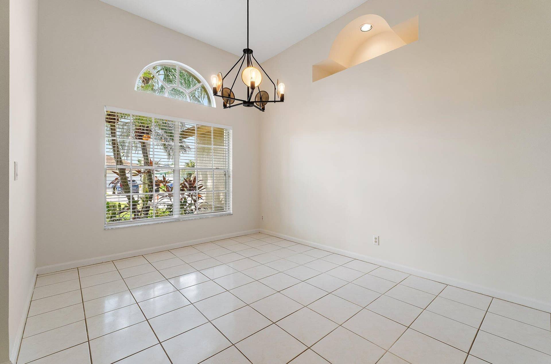 6037 Foster Street, Jupiter, FL 33458 Dining room with a chandelier and arched windows.