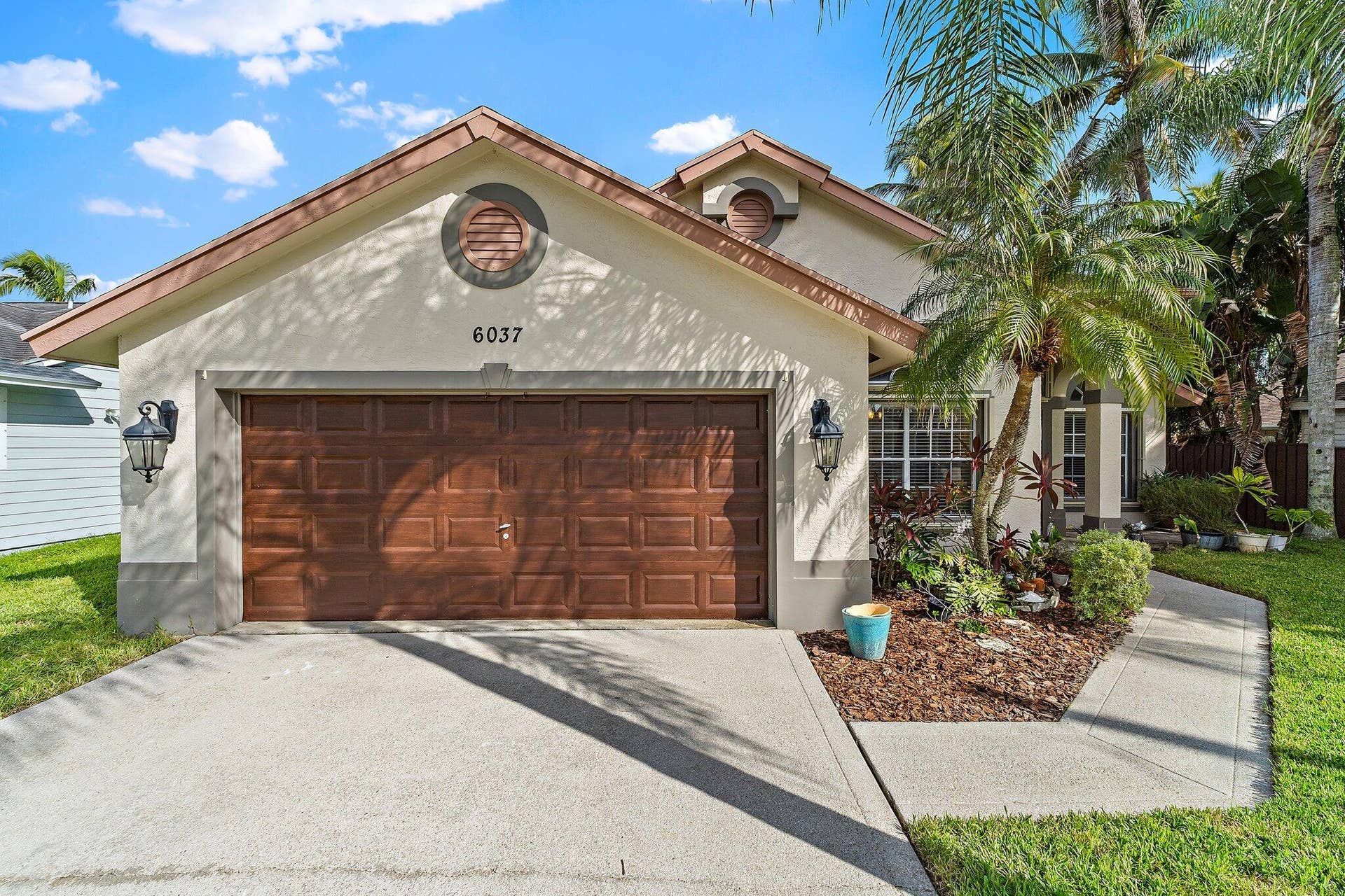 6037 Foster Street, Jupiter, FL 33458 Attached 2-car garage and driveway.