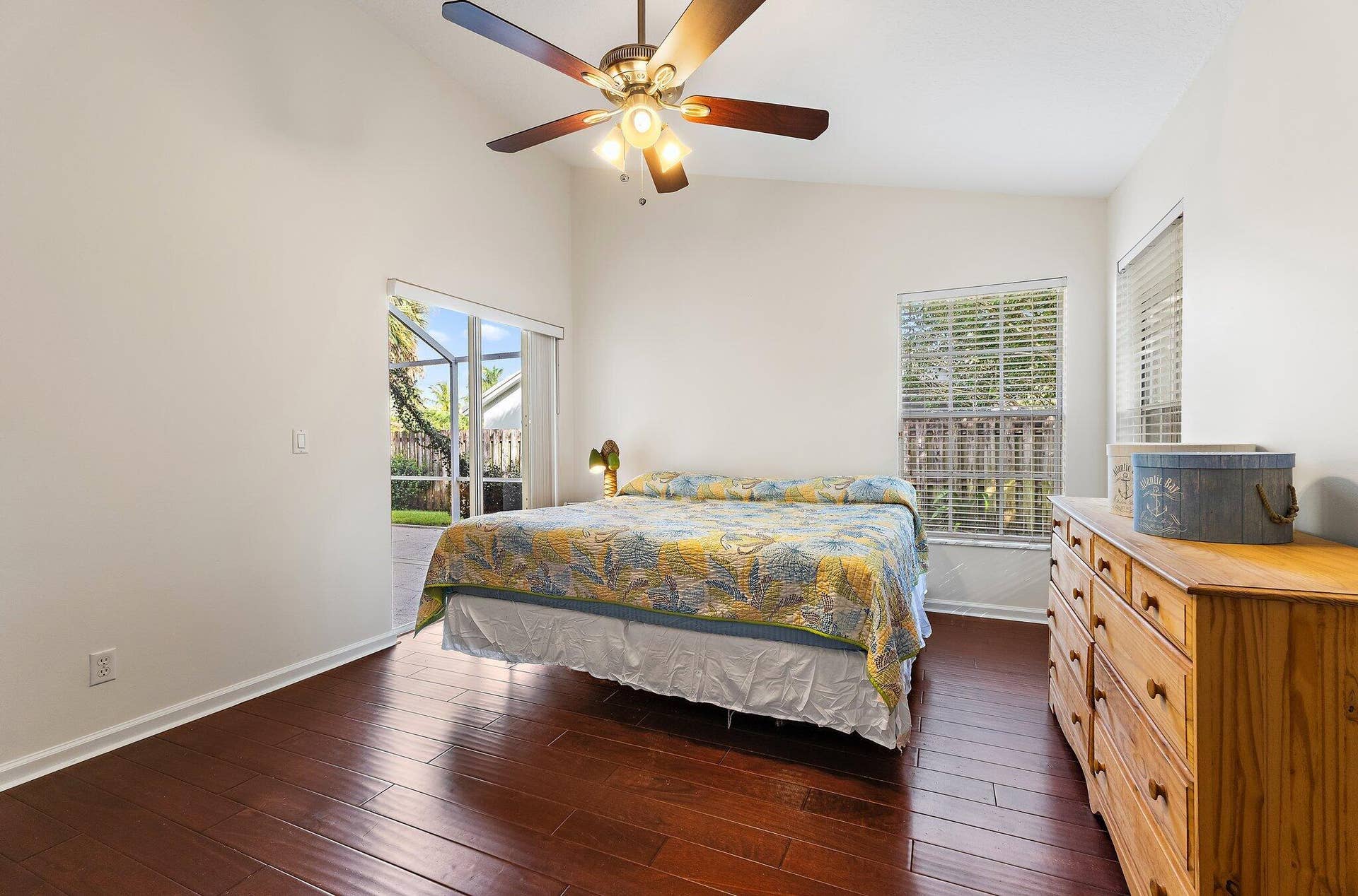 6037 Foster Street, Jupiter, FL 33458 Primary bedroom with wood floors and natural light.