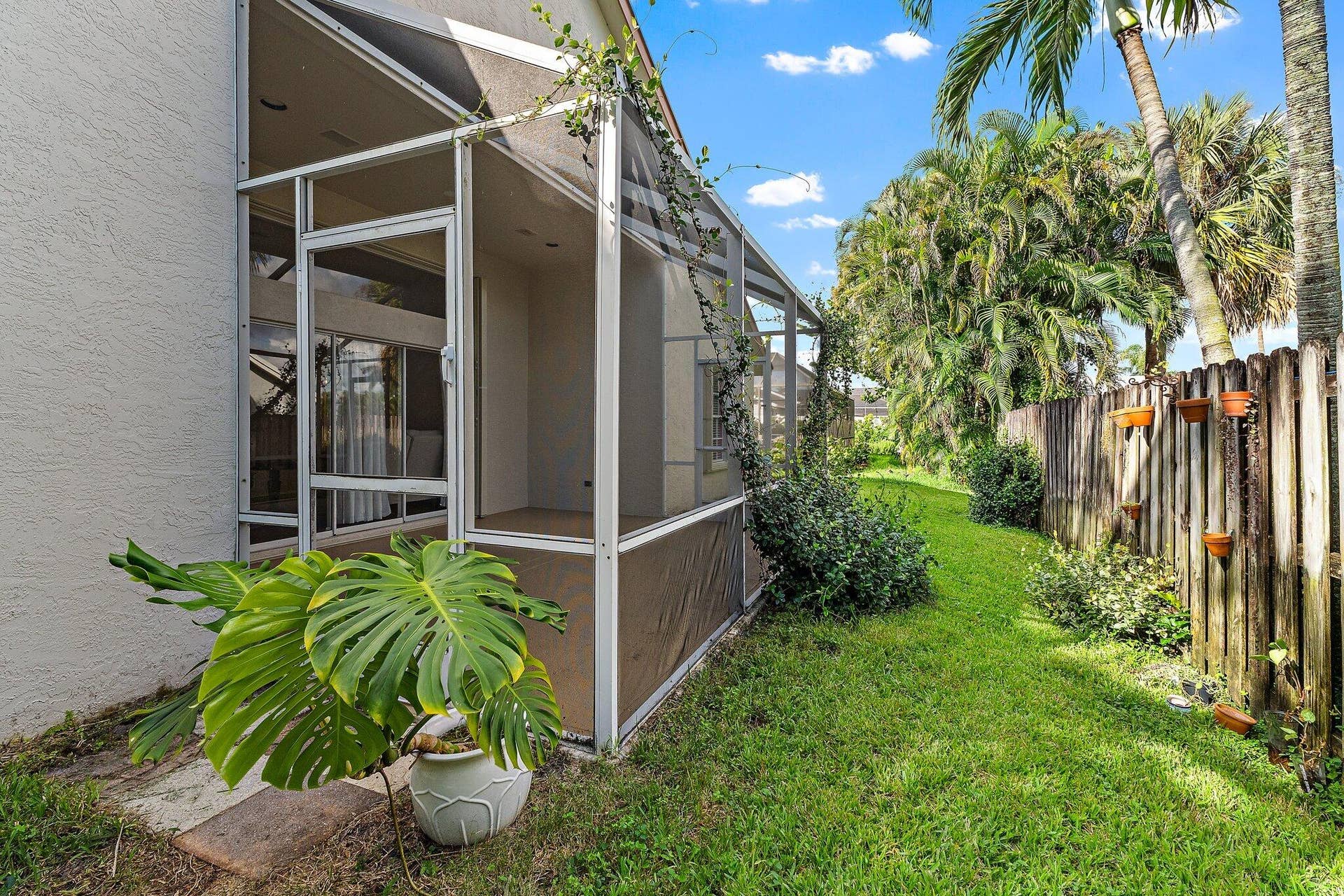 6037 Foster Street, Jupiter, FL 33458 Fenced backyard and the outside of the screened patio.