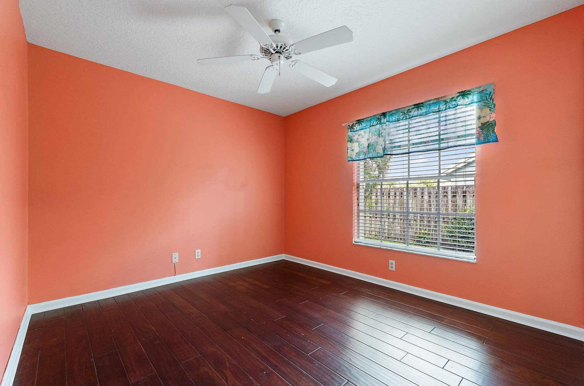 6037 Foster Street, Jupiter, FL 33458 Guest bedroom with wood floors and a ceiling fan.