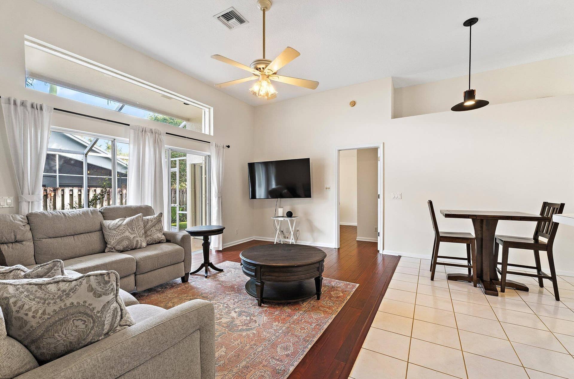 6037 Foster Street, Jupiter, FL 33458 Family room open to the dining area, with glass doors to the patio.