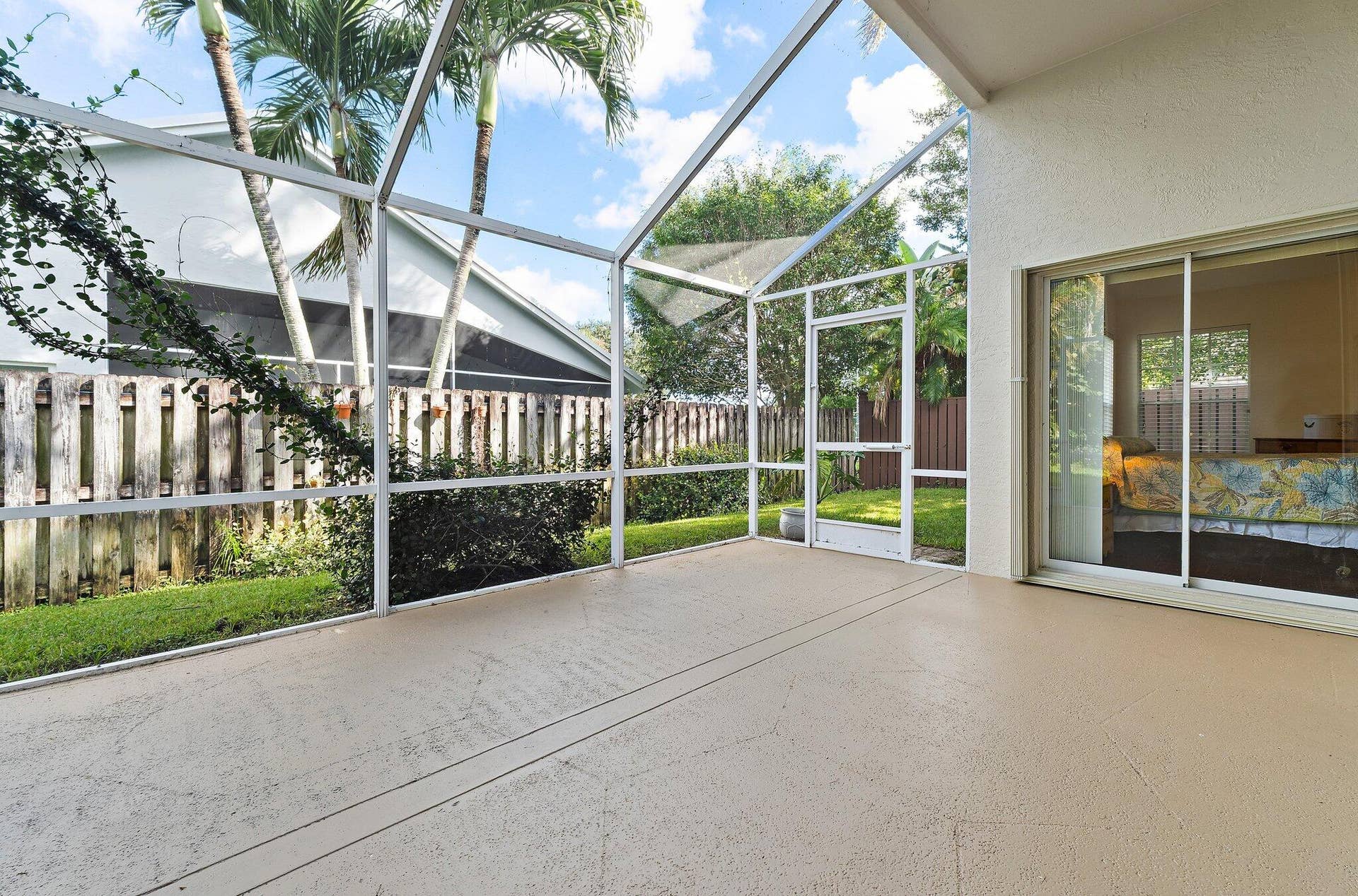 6037 Foster Street, Jupiter, FL 33458 Screened patio with sliding glass doors to the primary bedroom and living room.