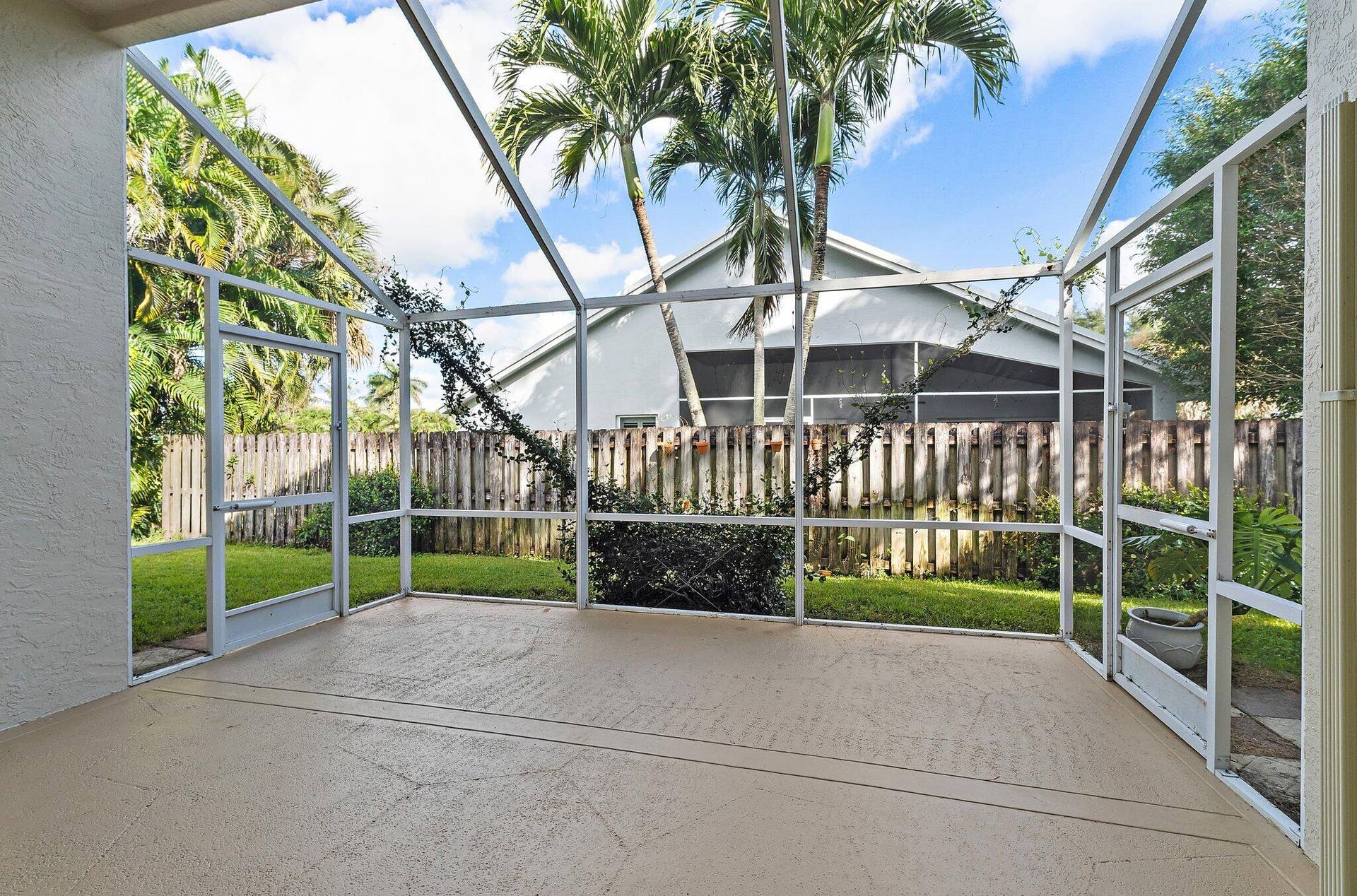 6037 Foster Street, Jupiter, FL 33458 Screened patio overlooking the fenced backyard.