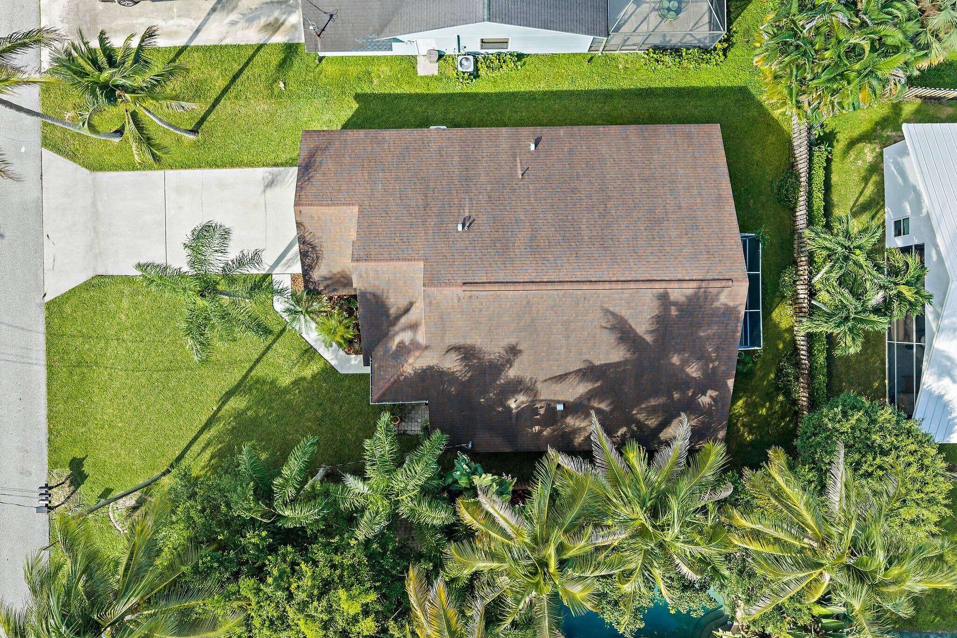 6037 Foster Street, Jupiter, FL 33458 Overhead aerial of the home, yard and mature palms.