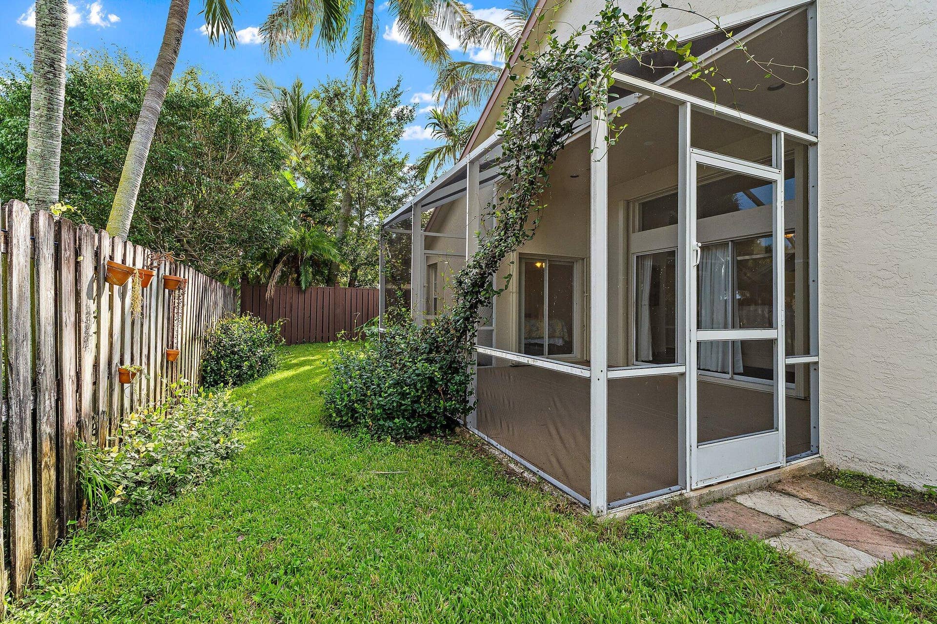 6037 Foster Street, Jupiter, FL 33458 Backyard with privacy fence and screened patio.