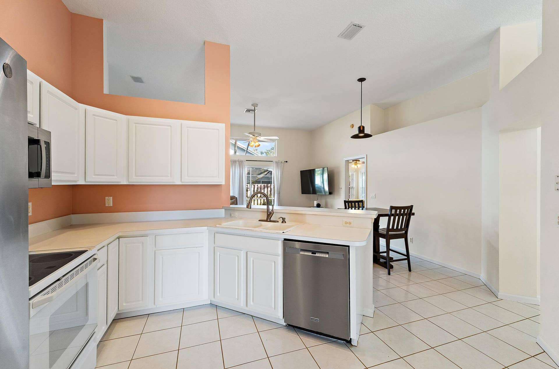6037 Foster Street, Jupiter, FL 33458 Kitchen with a breakfast bar open to the dining area.