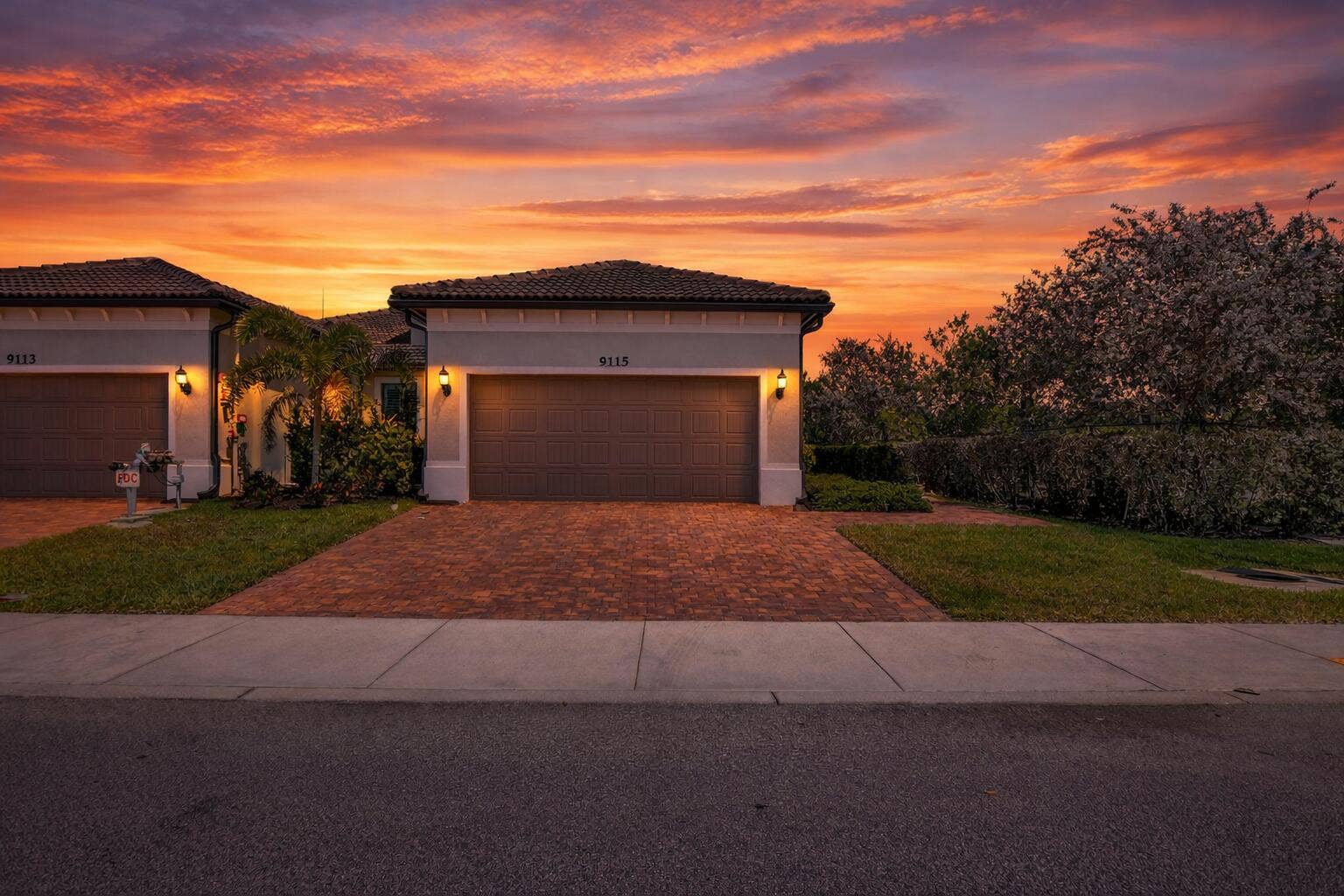 9115 Passiflora Way, Boca Raton, FL 33428 Suburban home at sunset with flowers