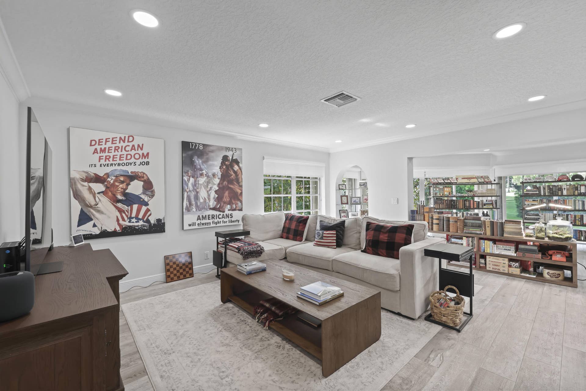137 Clubhouse Boulevard, Atlantis, FL 33462 Open-concept living space featuring wood-finish flooring, recessed lighting, multi-pane windows, and an arched architectural opening