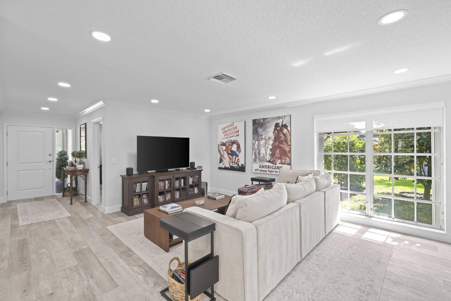 137 Clubhouse Boulevard, Atlantis, FL 33462 Open-concept interior featuring light wood-finish flooring, recessed lighting, and large grid-pattern windows