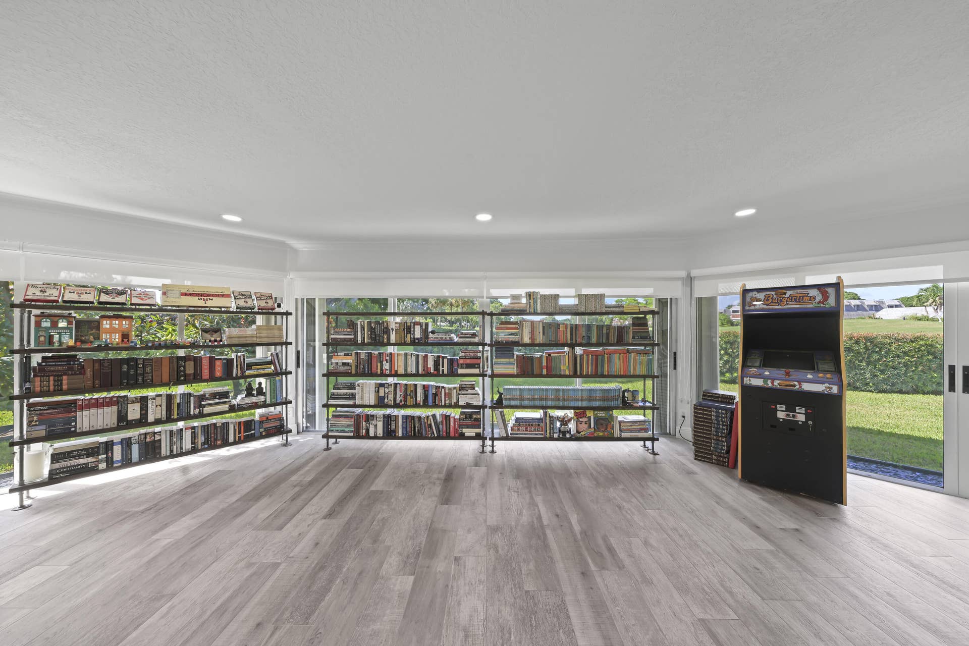 137 Clubhouse Boulevard, Atlantis, FL 33462 Spacious room featuring wood-finish flooring, recessed lighting, and floor-to-ceiling glass sliding doors with access to the exterior