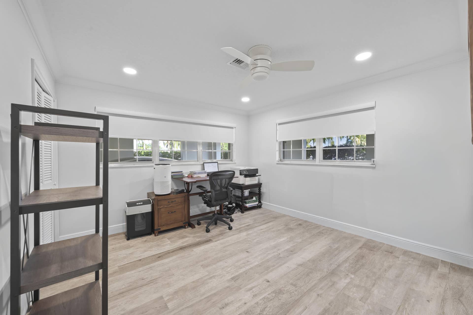 137 Clubhouse Boulevard, Atlantis, FL 33462 Room featuring wood-finish flooring, recessed lighting, white louvered closet doors, multi-pane windows, and a central ceiling fan