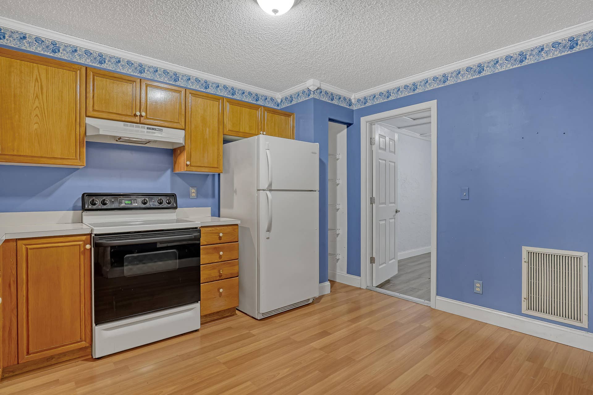 Kitchen with door to extra converted room