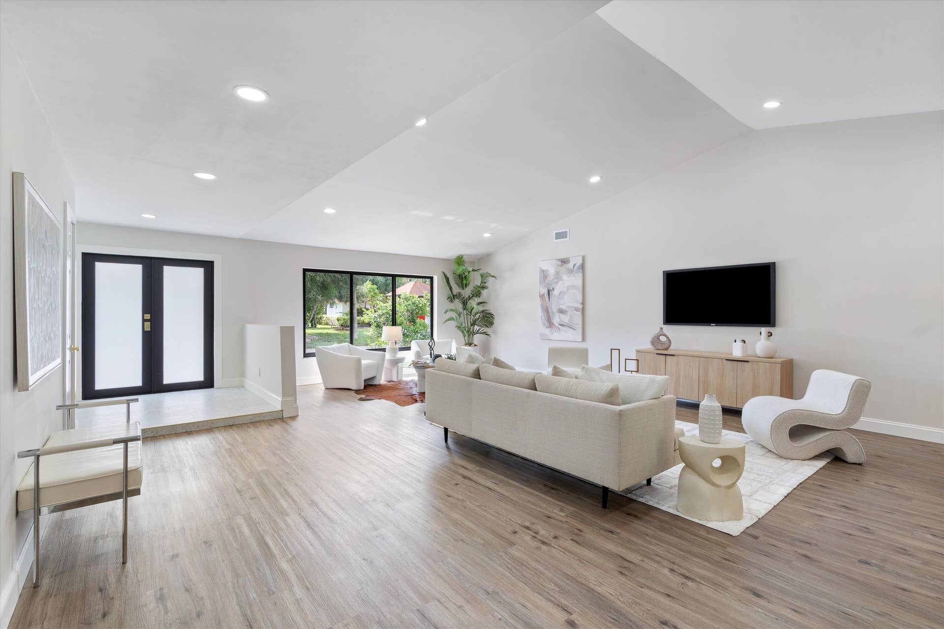 6111 WHITE OAK Lane, Tamarac, FL 33319 Vaulted ceilings, wood-finish flooring, recessed lighting, and black-framed windows featuring double entry doors