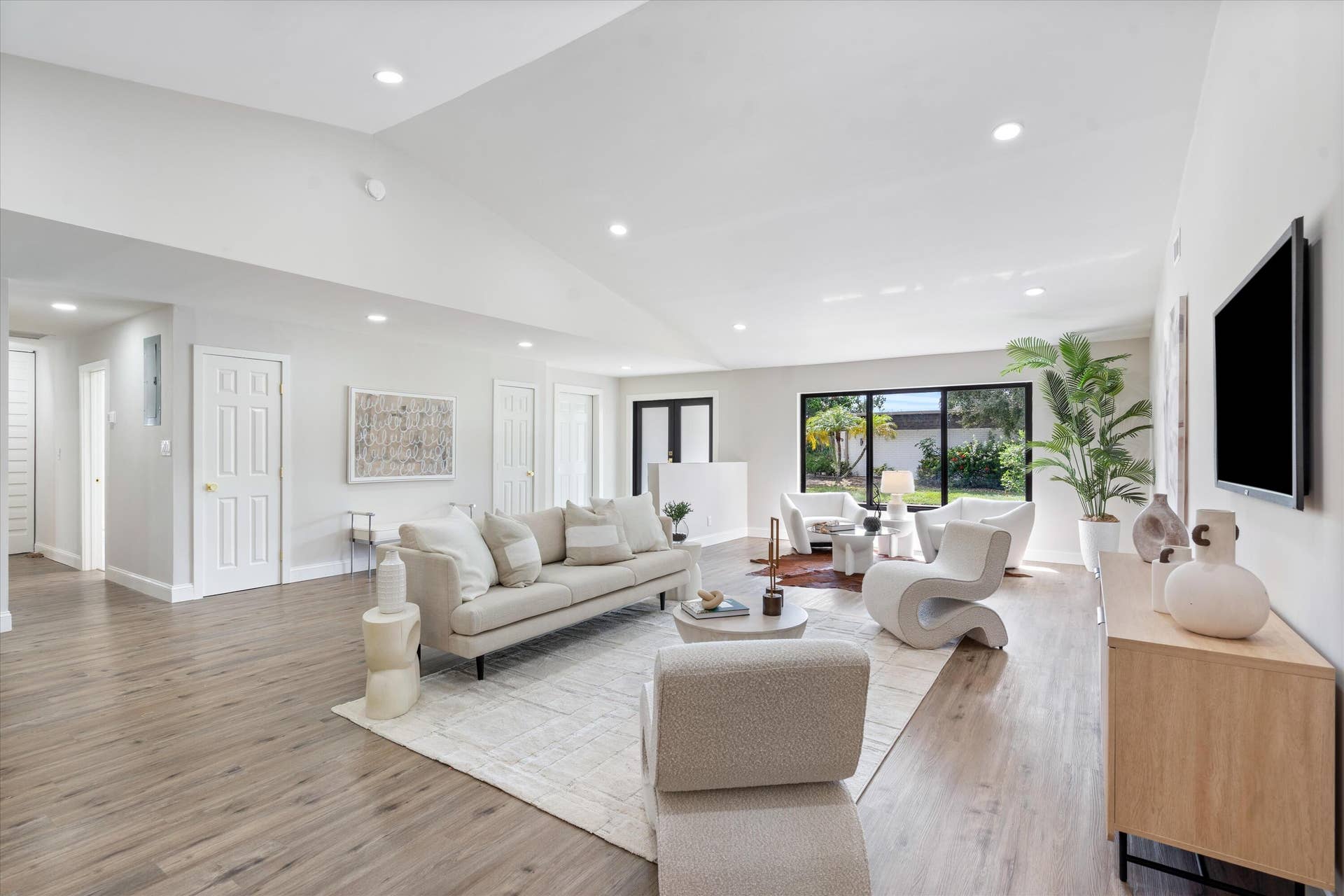 6111 WHITE OAK Lane, Tamarac, FL 33319 Vaulted ceilings, wood-finish flooring, recessed lighting, and expansive windows
