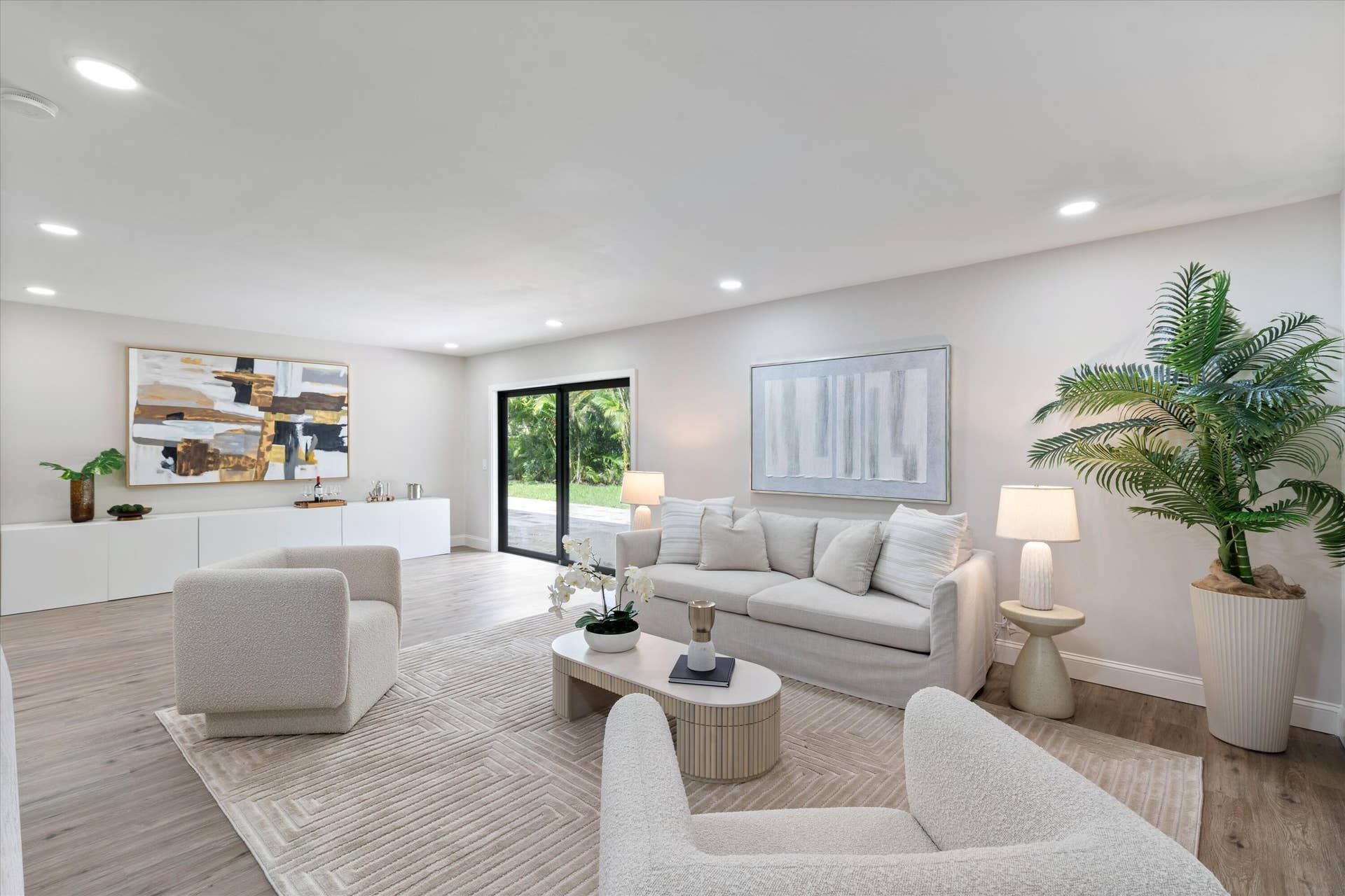 6111 WHITE OAK Lane, Tamarac, FL 33319 Open-concept interior featuring wood-finish flooring, recessed lighting, and black-framed sliding glass doors
