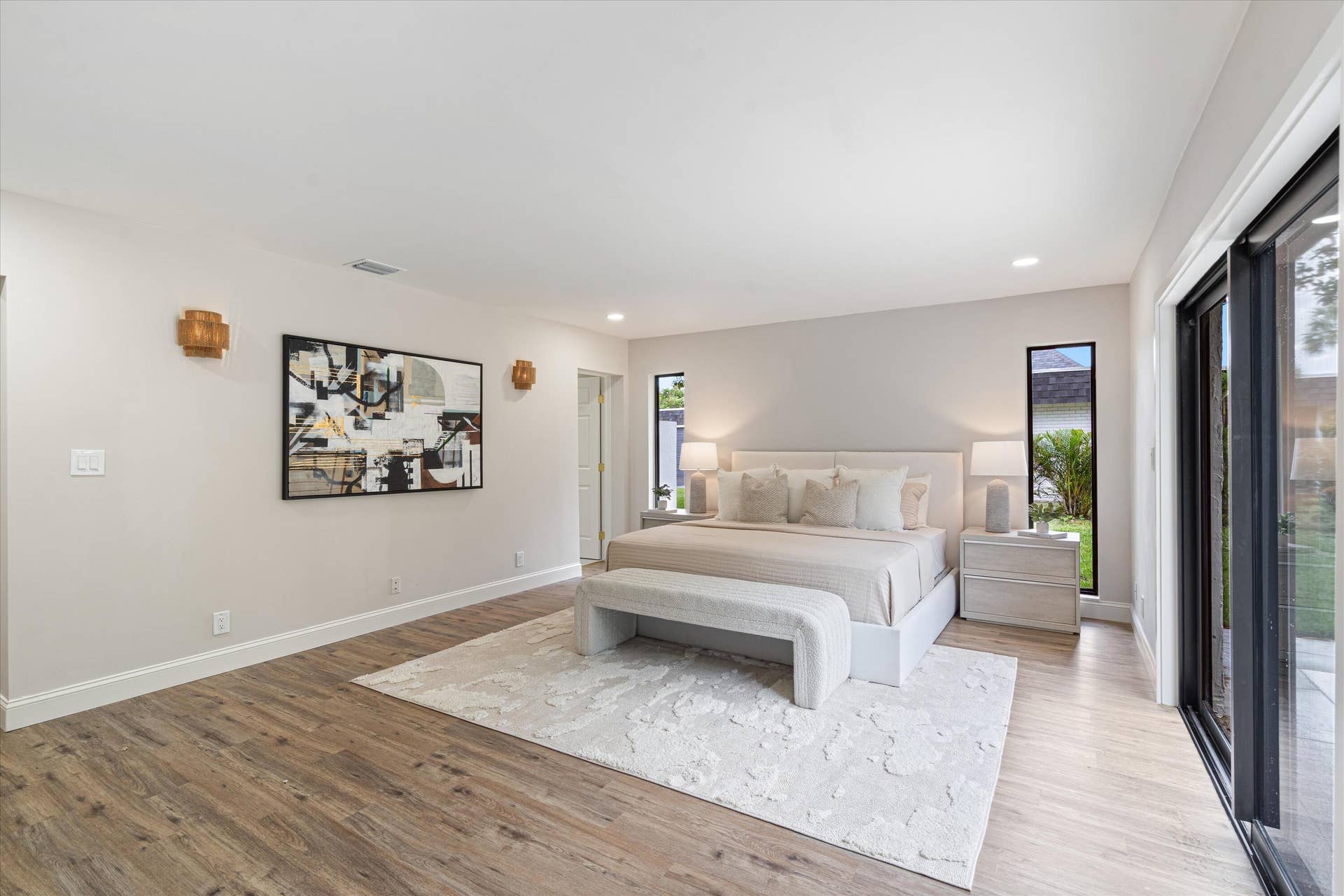 6111 WHITE OAK Lane, Tamarac, FL 33319 Wood-finish flooring, recessed ceiling lighting, wall-mounted light fixtures, and floor-to-ceiling sliding glass doors