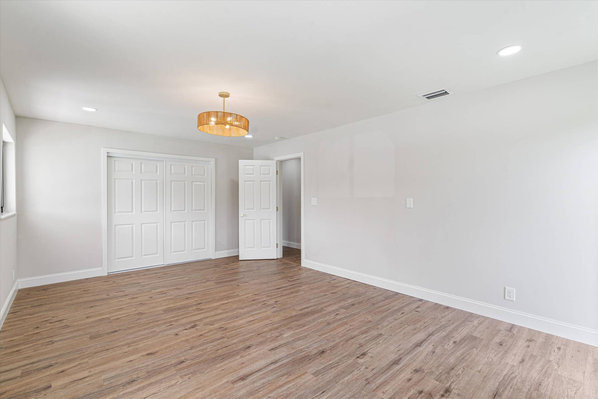 6111 WHITE OAK Lane, Tamarac, FL 33319 Interior space featuring wood-finish flooring, recessed lighting, a drum-style chandelier, and paneled closet doors