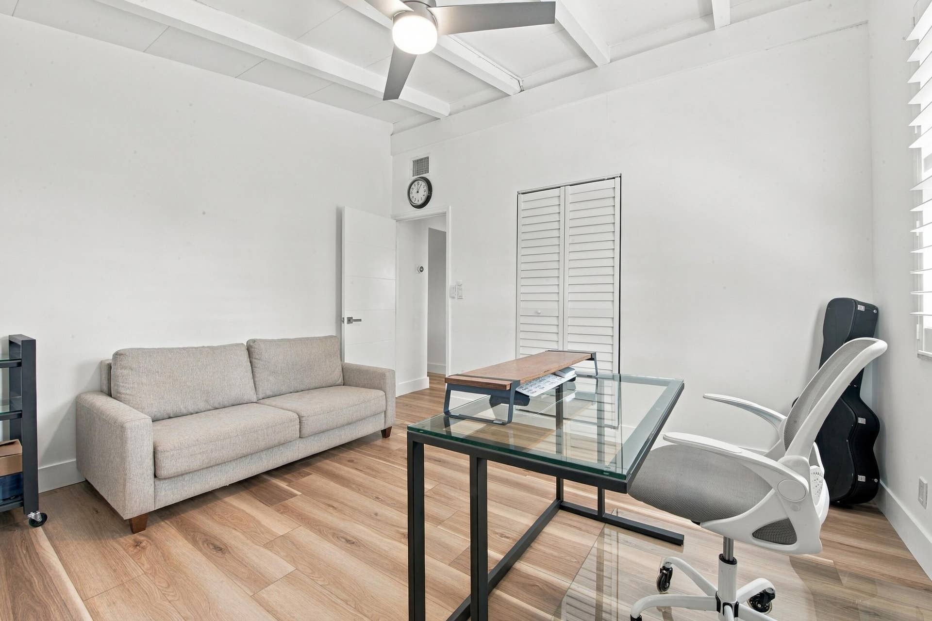 2449 KEY LARGO Lane, Fort Lauderdale, FL 33312 Room featuring wood-finish flooring, exposed ceiling beams, a ceiling fan, and louvered-panel closet doors