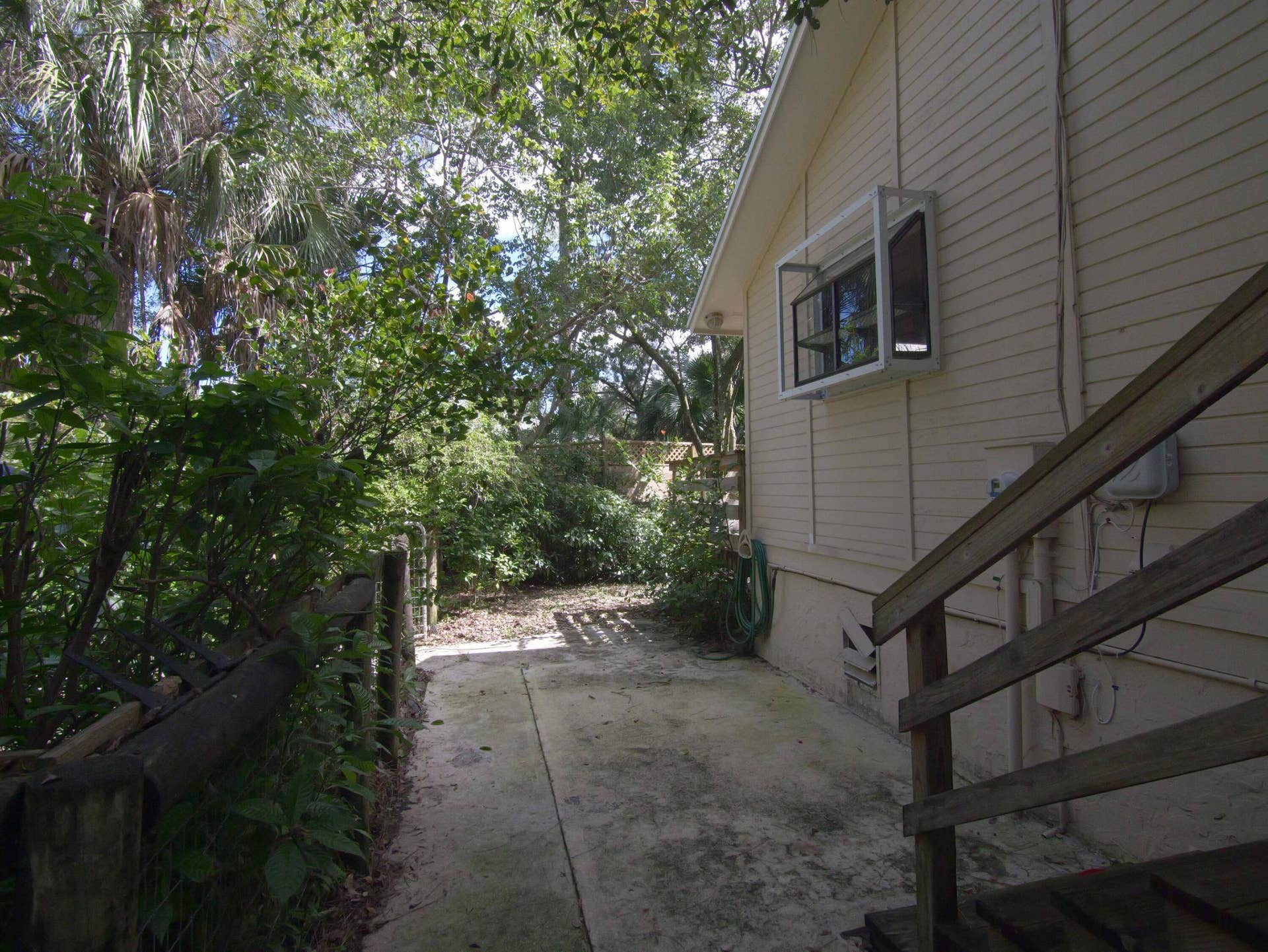 17032 130TH Avenue N, Jupiter, FL 33478 Walkway from home to Garage & backyard