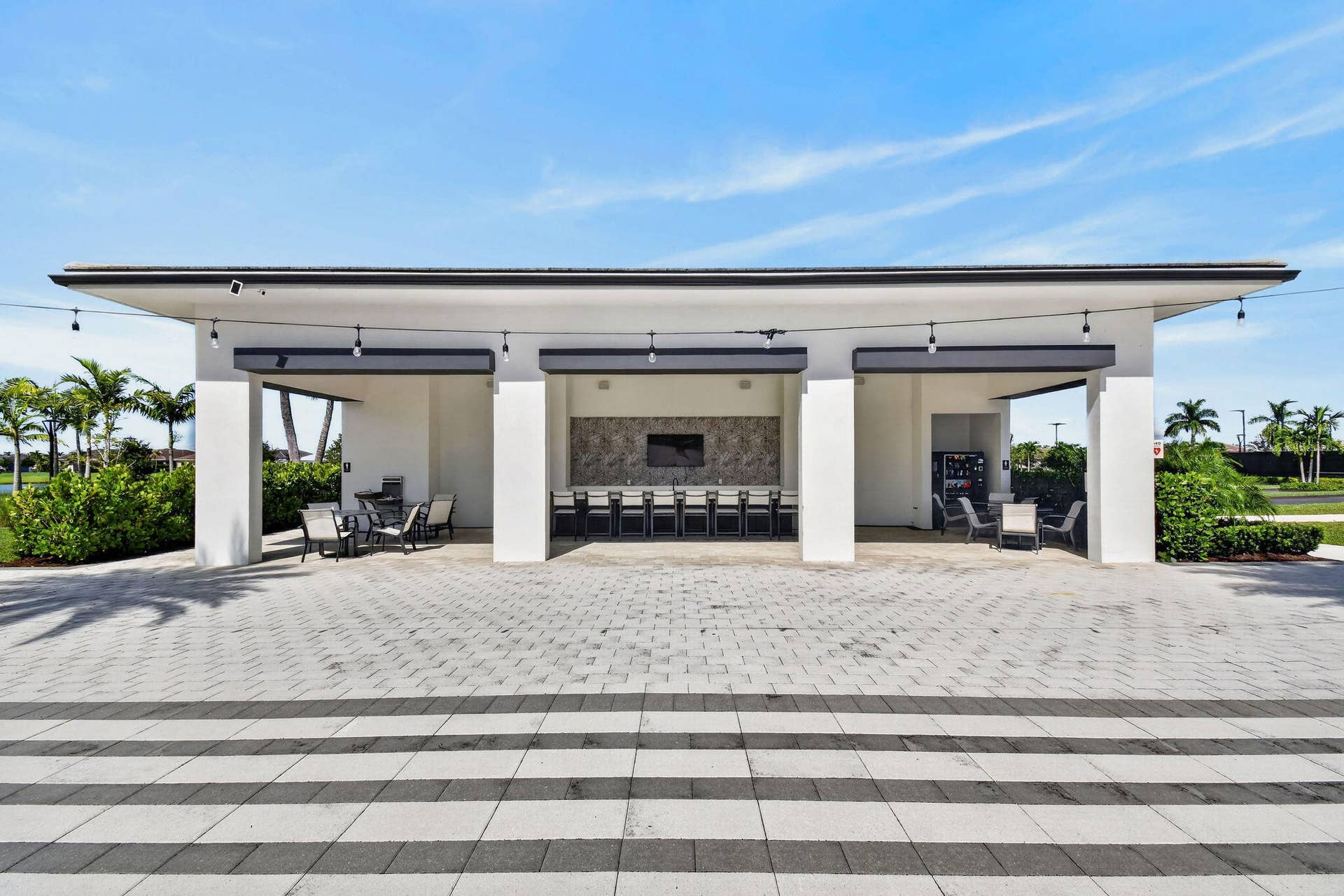 15811 Key Biscayne Lane, Westlake, FL 33470 Expansive outdoor structure featuring a covered dining area, built-in grill, and a stone-finish accent wall