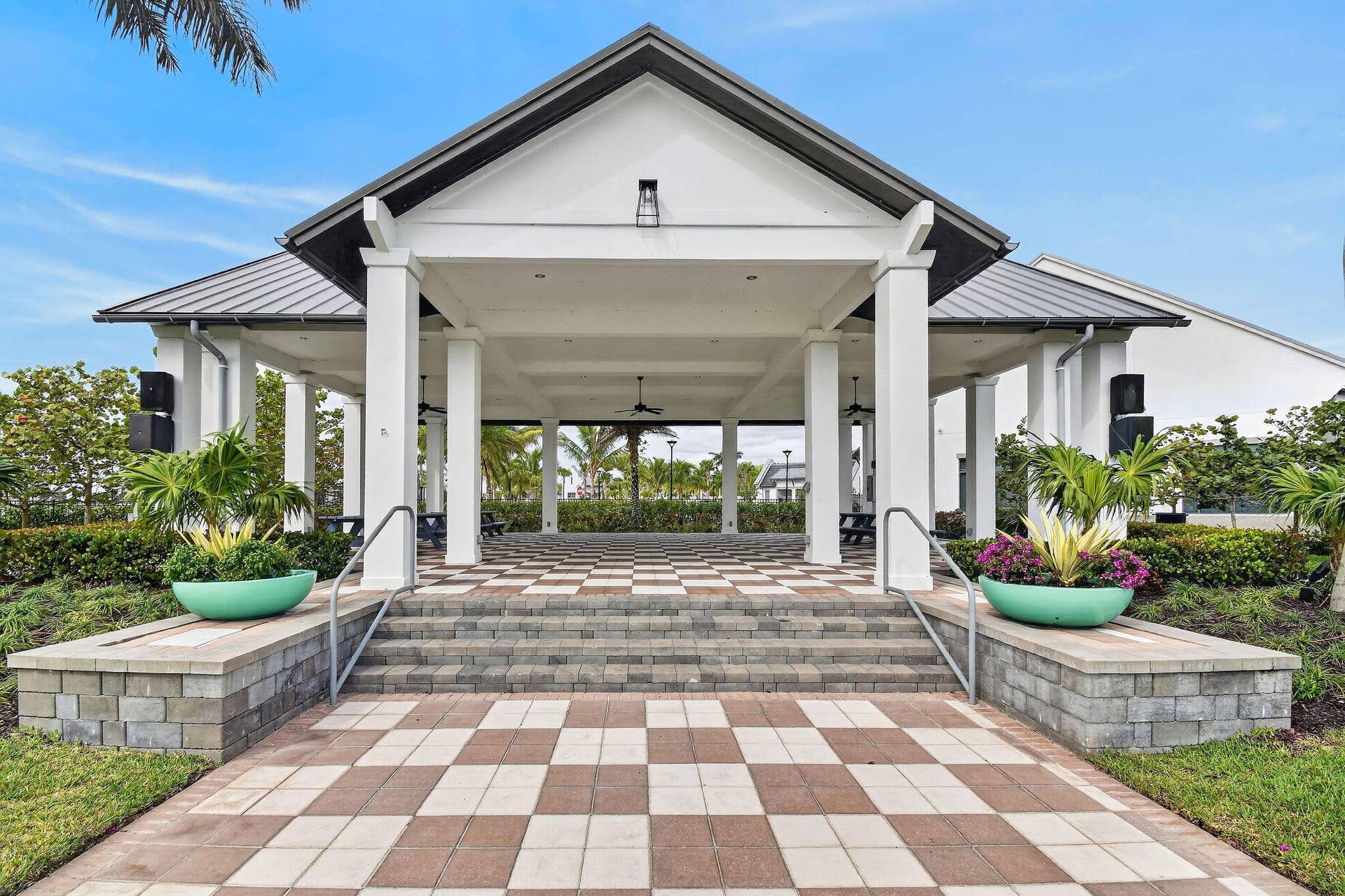 15811 Key Biscayne Lane, Westlake, FL 33470 Expansive covered patio featuring a gabled roofline, checkerboard paver flooring, and multiple support columns