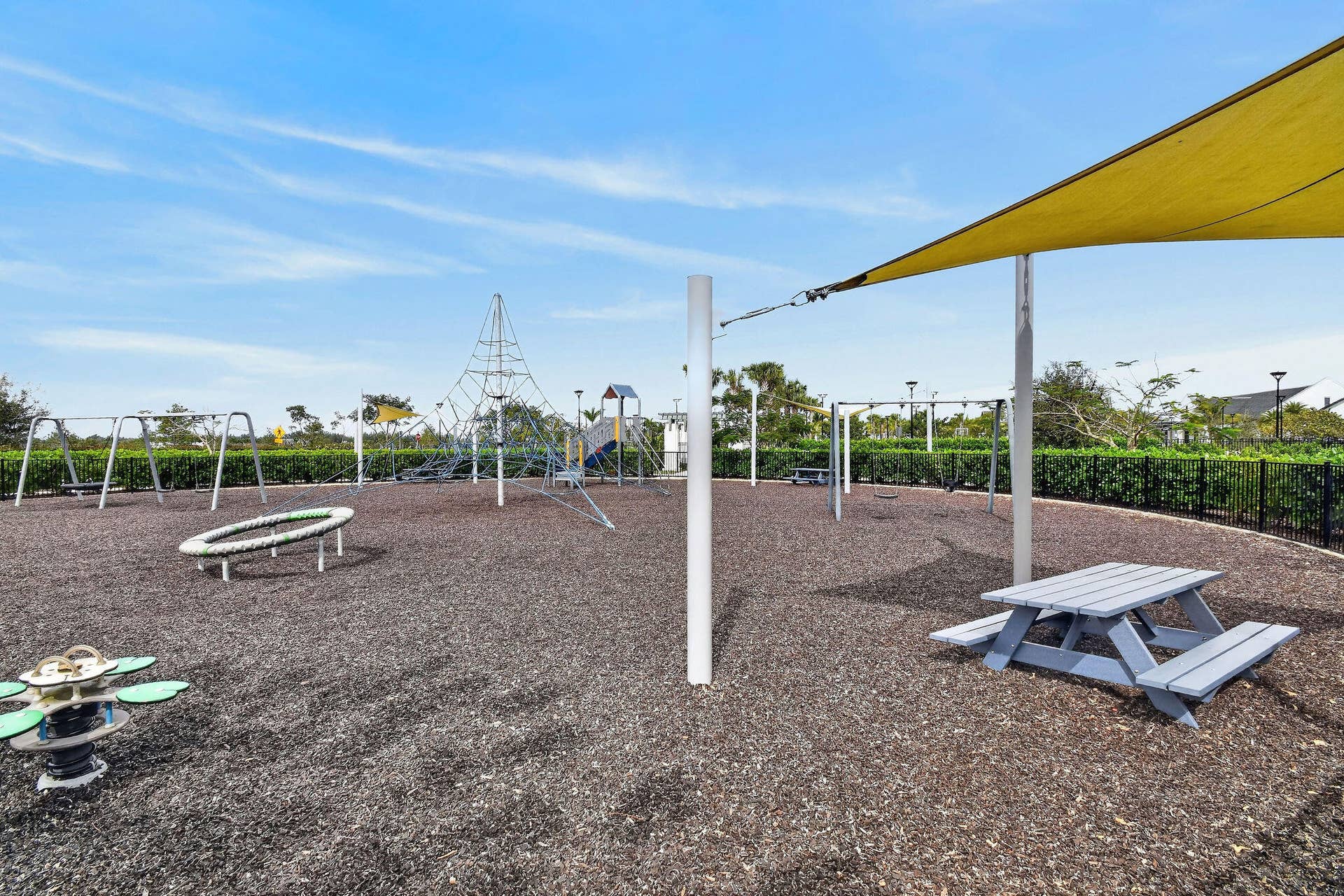 15811 Key Biscayne Lane, Westlake, FL 33470 Community playground featuring diverse equipment, a shaded picnic area, and a protective ground surface