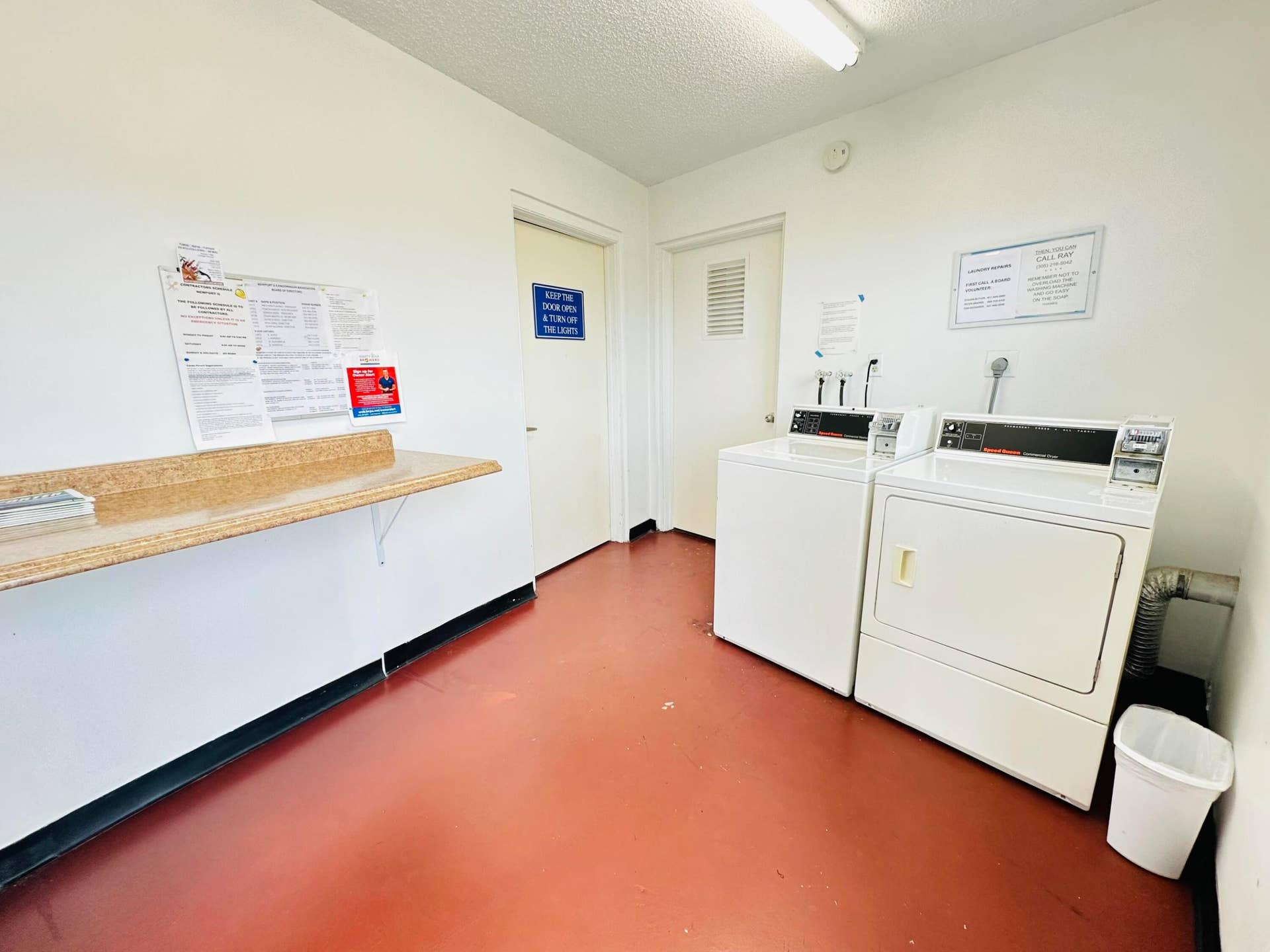 4011 NEWPORT G, Deerfield Beach, FL 33442 Laundry area featuring a wall-mounted laminate folding counter and solid-surface flooring