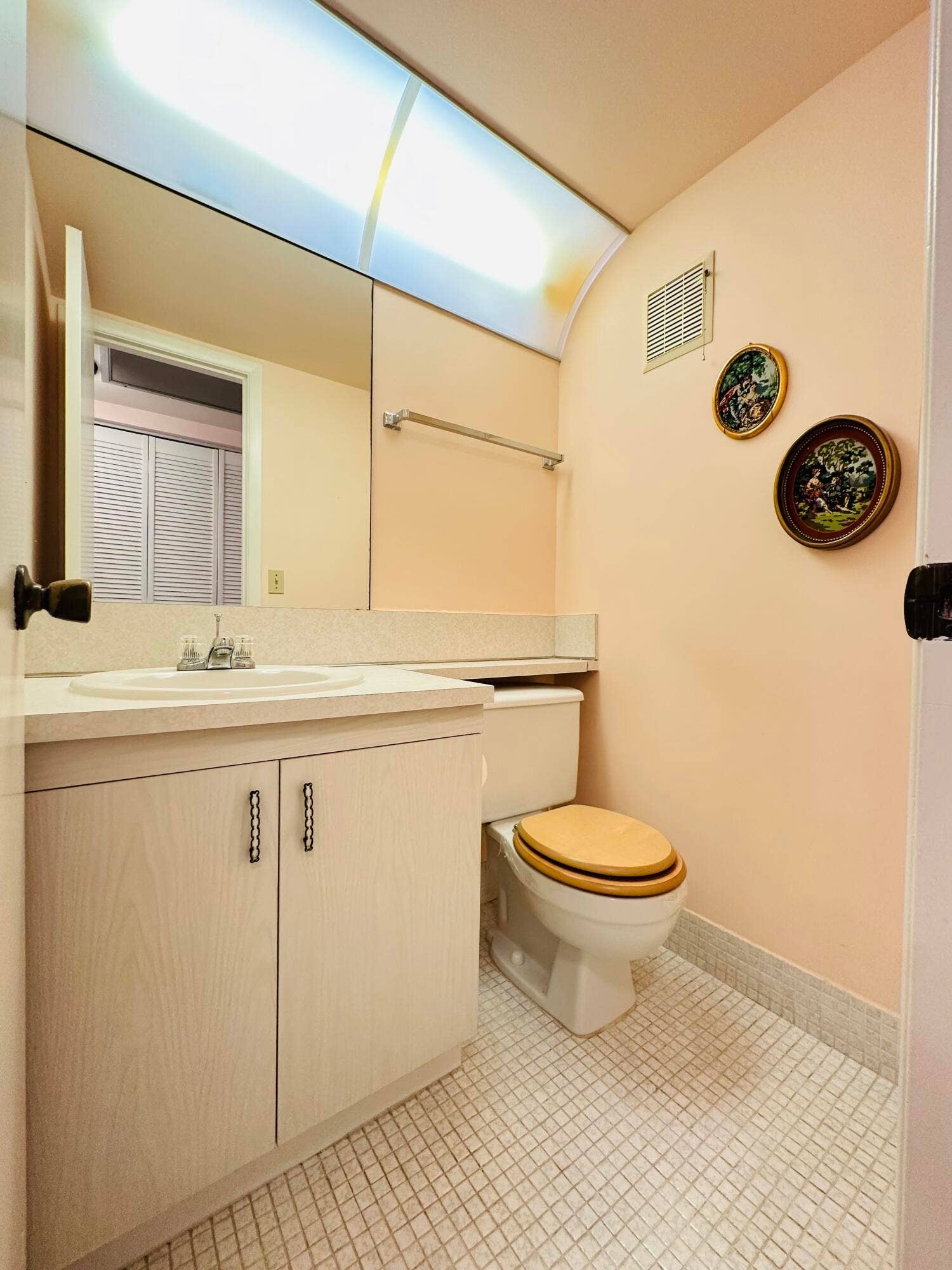 4011 NEWPORT G, Deerfield Beach, FL 33442 Bathroom featuring a vanity with light-tone cabinetry and an integrated sink, a full-width wall mirror, recessed lighting with a diffuser panel, and ceramic tile flooring