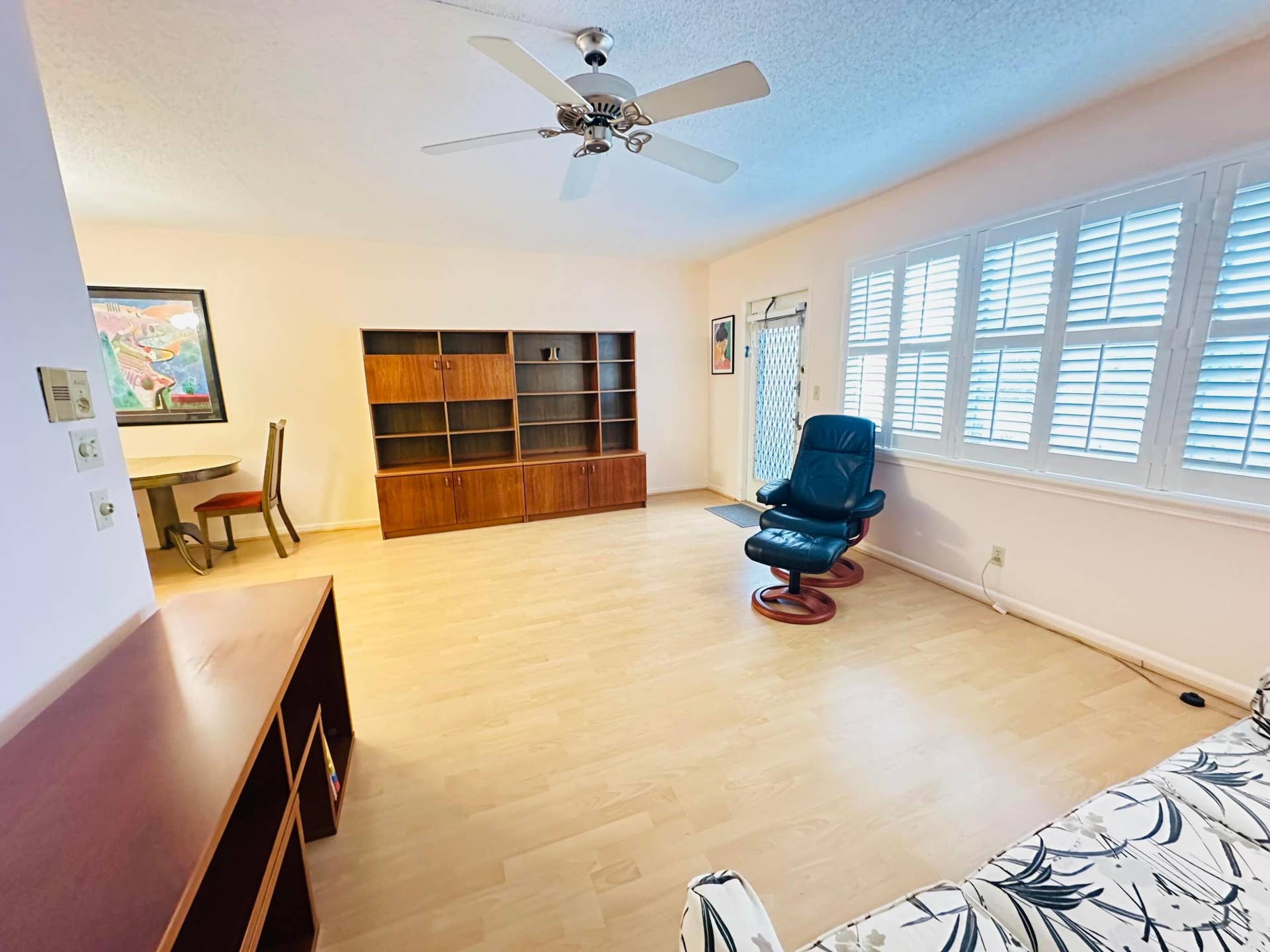 4011 NEWPORT G, Deerfield Beach, FL 33442 Light laminate flooring, plantationa shutters & ceiling fan with light fixture, and plantation shutters