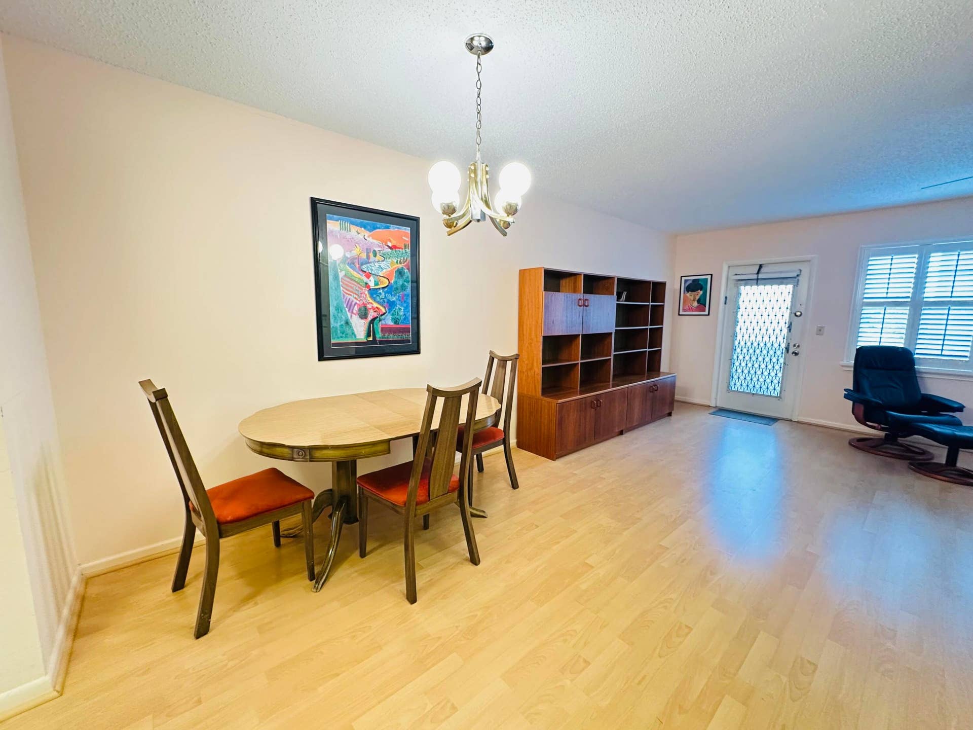 4011 NEWPORT G, Deerfield Beach, FL 33442 Laminate flooring, multi-bulb metal chandelier, and plantation shutters