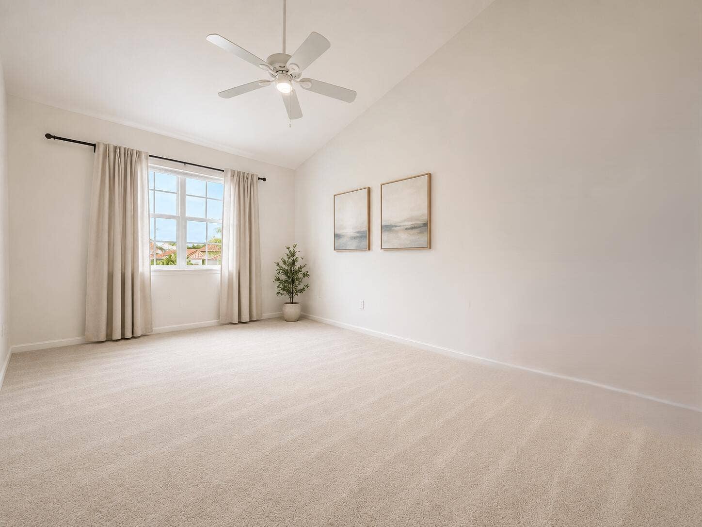 Vaulted ceiling featuring a central light-integrated ceiling fan, carpeted flooring, and a multi-pane window