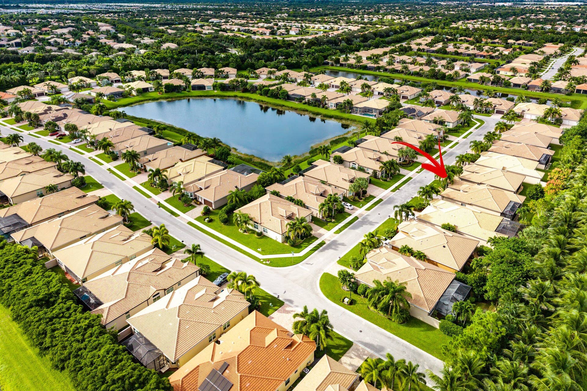 Aerial perspective featuring tile roofing, concrete paved streets, and residential landscaping within a suburban community