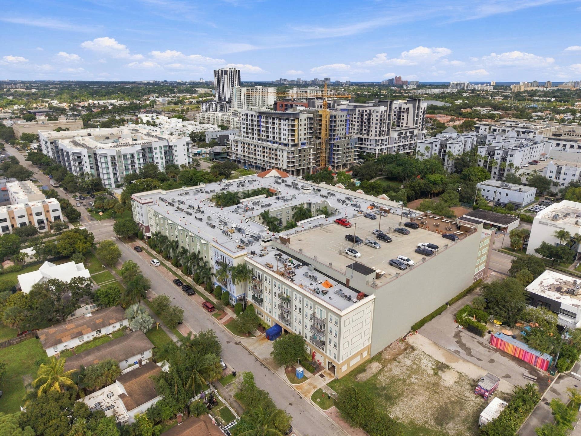 533 NE 3RD Avenue, #202, Fort Lauderdale, FL 33301 Multi-story residential complex featuring a rooftop parking deck, central courtyard, and exterior balconies