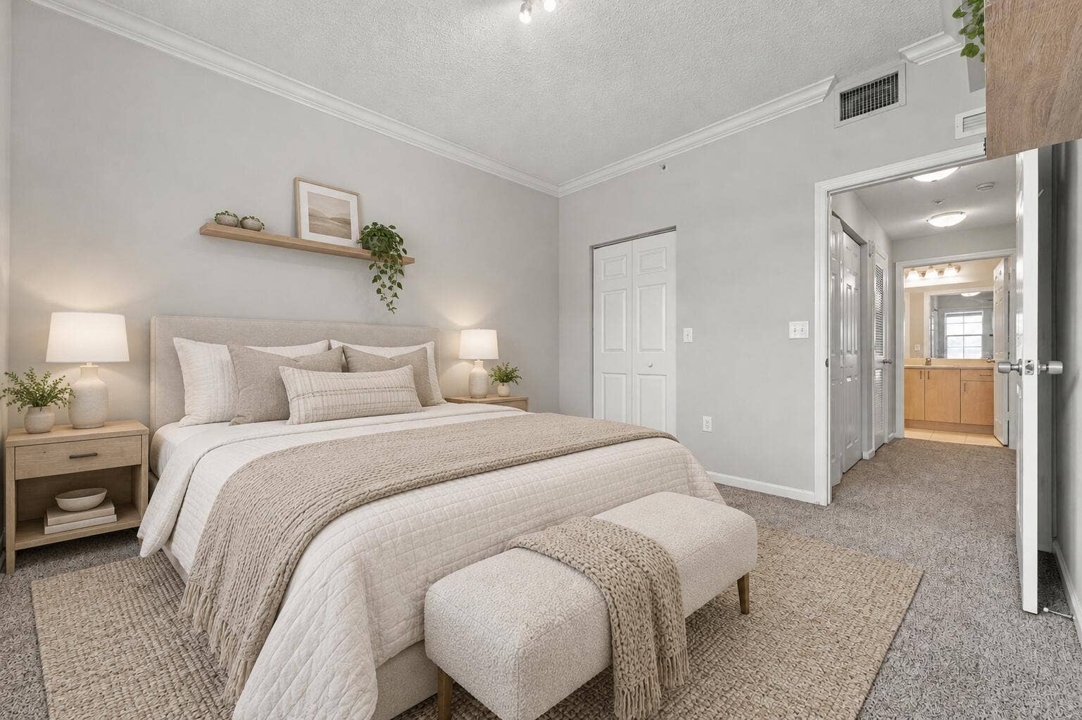 533 NE 3RD Avenue, #202, Fort Lauderdale, FL 33301 Neutral-toned interior featuring crown molding, wall-mounted floating shelving, and carpeted flooring