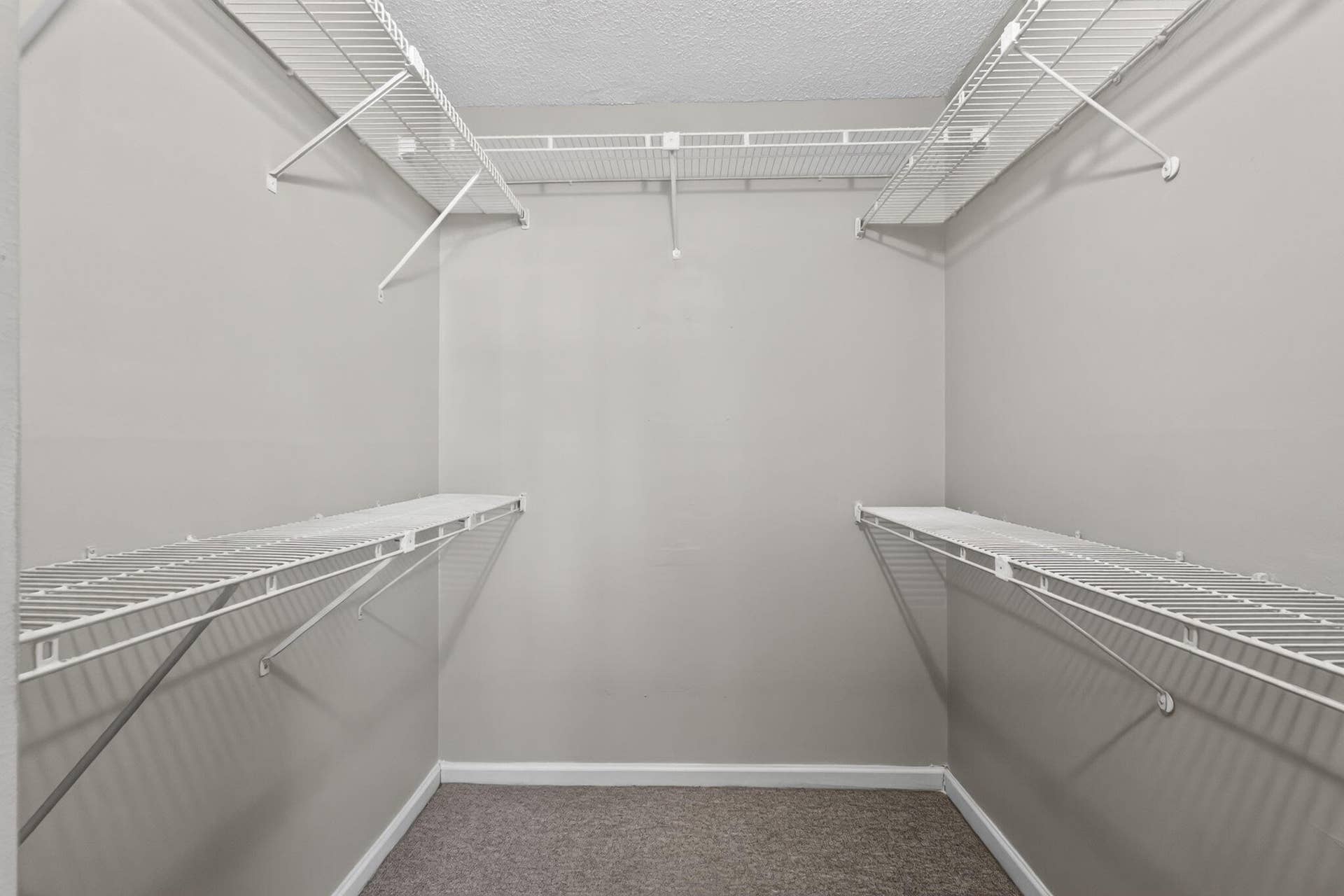 14527 BONAIRE Boulevard, #109, Delray Beach, FL 33446 Walk-in storage space featuring neutral wall paint, high-density carpeting, and tiered white wire shelving