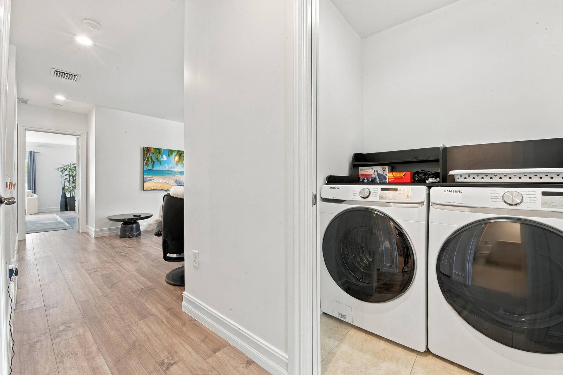 1752 NE 12TH Street, Fort Lauderdale, FL 33304 Laundry alcove featuring wood-finish flooring, recessed lighting, and built-in upper shelving