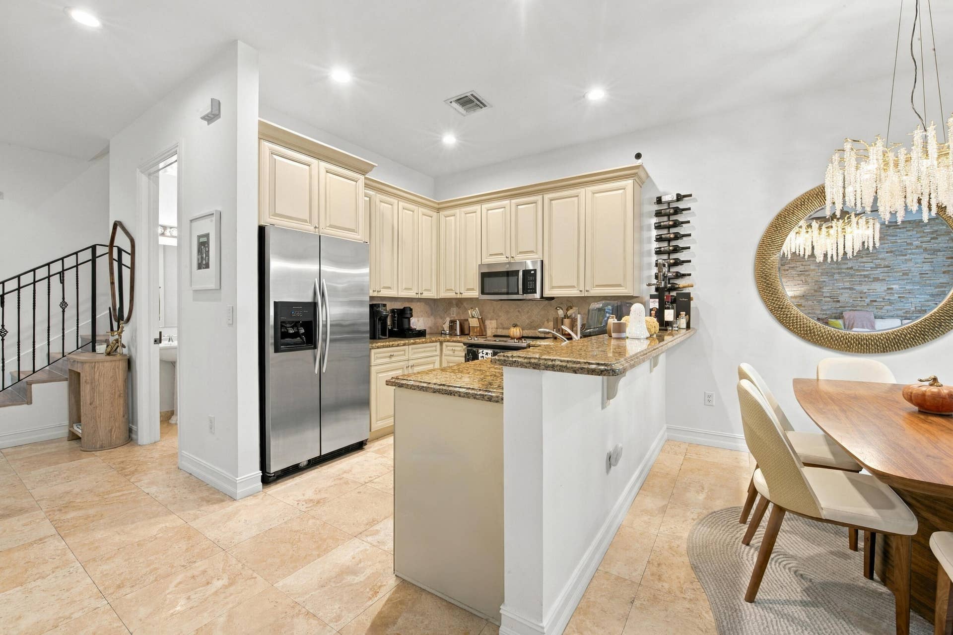 1752 NE 12TH Street, Fort Lauderdale, FL 33304 Kitchen featuring stone countertops, stainless steel refrigerator, stone flooring, recessed lighting, and crown-molded cabinetry