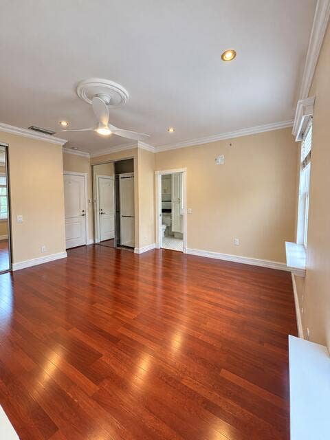 477 Capistrano Drive, Palm Beach Gardens, Palm Beach Gardens, FL 33410 Wood-finish flooring, recessed lighting, crown molding, ceiling fan with decorative medallion, and mirrored sliding closet doors