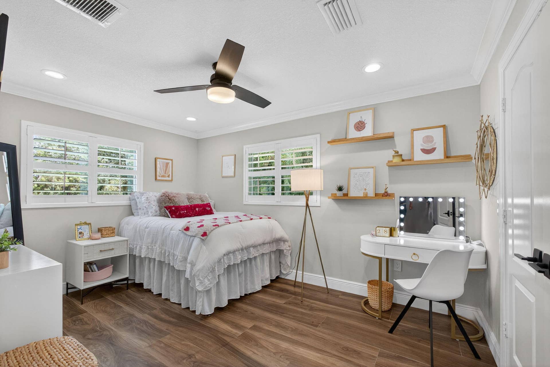 4628 Square Lake Drive, Palm Beach Gardens, FL 33418 Neutral-toned room featuring wood-finish flooring, plantation shutters, recessed lighting, a modern ceiling fan, and built-in wall shelving