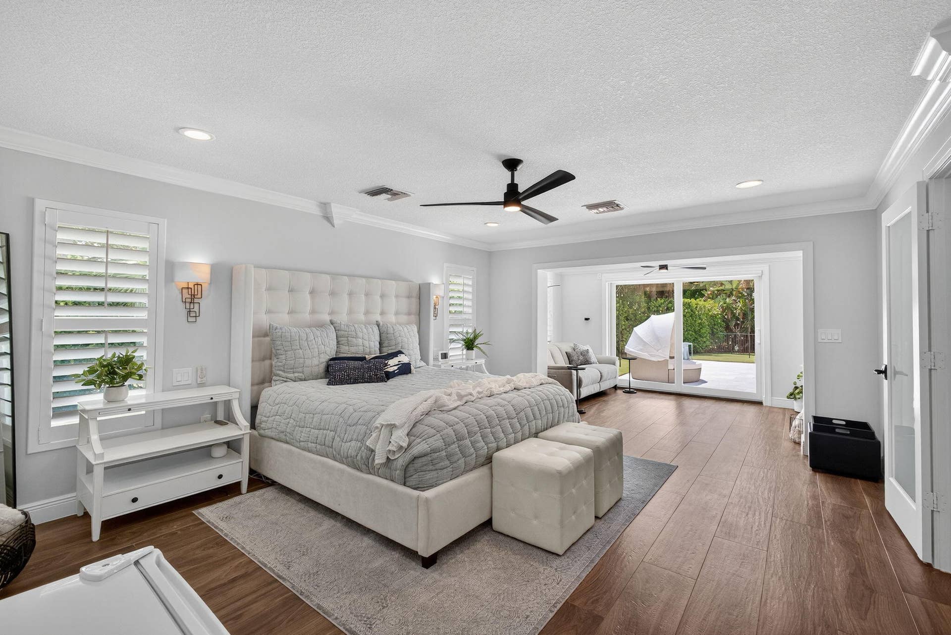 4628 Square Lake Drive, Palm Beach Gardens, FL 33418 Wood-finish flooring, crown molding, recessed lighting, ceiling fan with integrated light, and sliding glass doors
