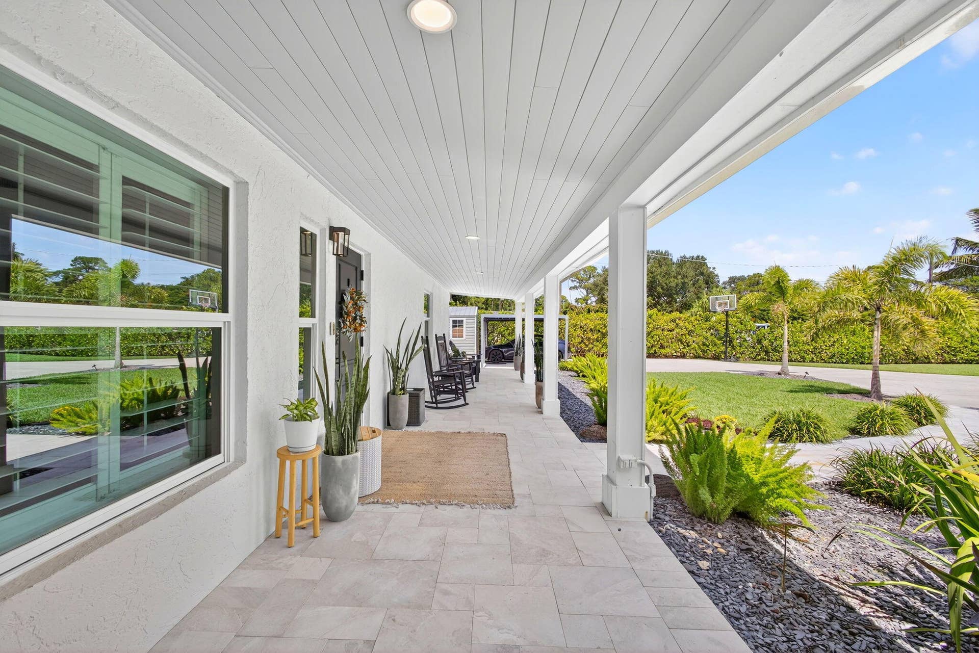 4628 Square Lake Drive, Palm Beach Gardens, FL 33418 Covered porch featuring light-toned tile flooring, beadboard ceiling, recessed lighting, and white support columns