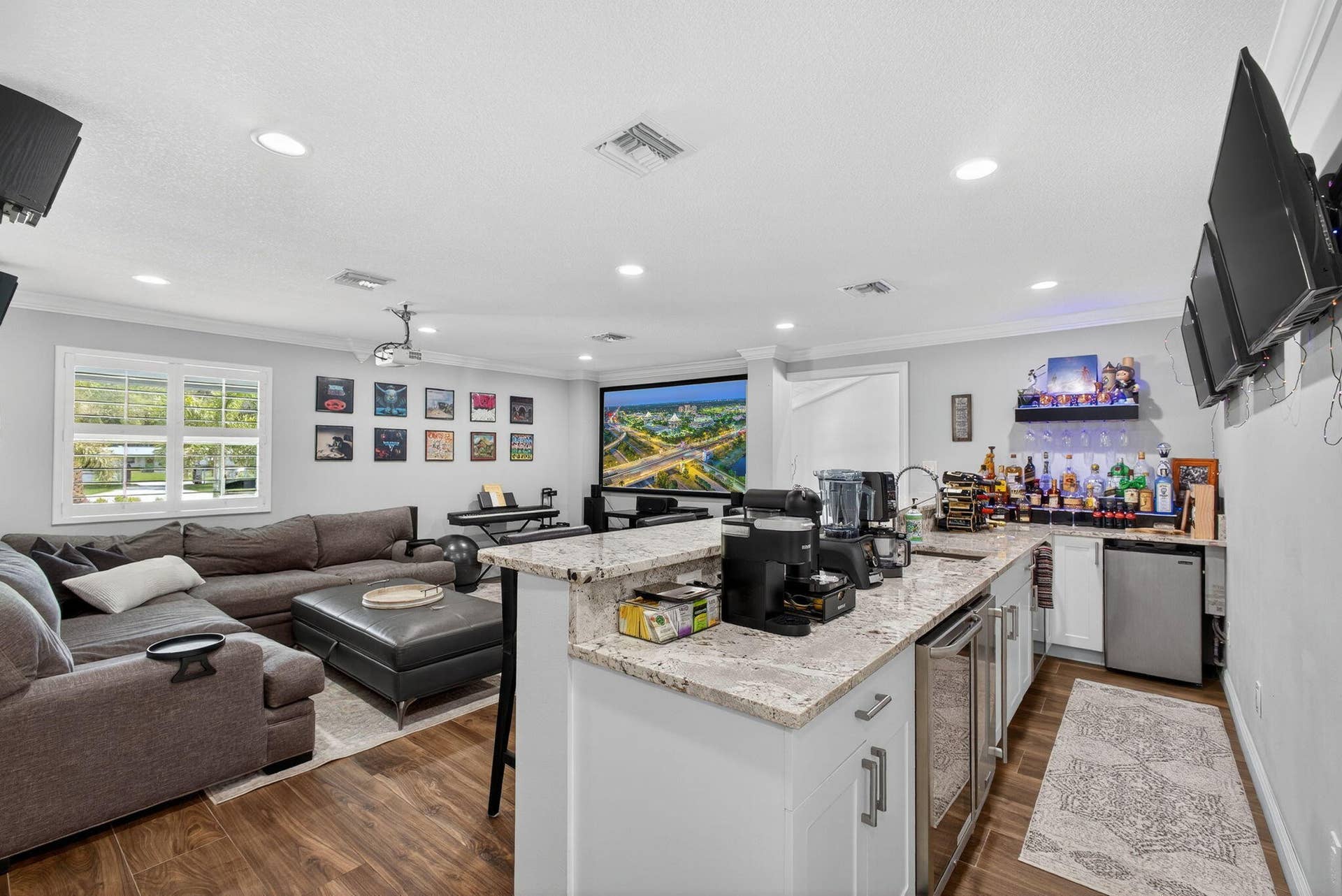 4628 Square Lake Drive, Palm Beach Gardens, FL 33418 Spacious room featuring wood-finish flooring, recessed lighting, and crown molding