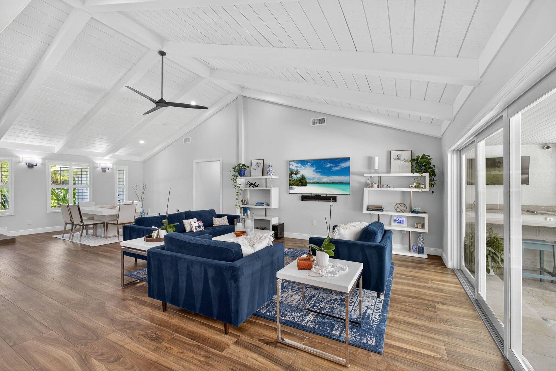 4628 Square Lake Drive, Palm Beach Gardens, FL 33418 Vaulted ceilings with exposed beams, wood-finish flooring, and sliding glass doors