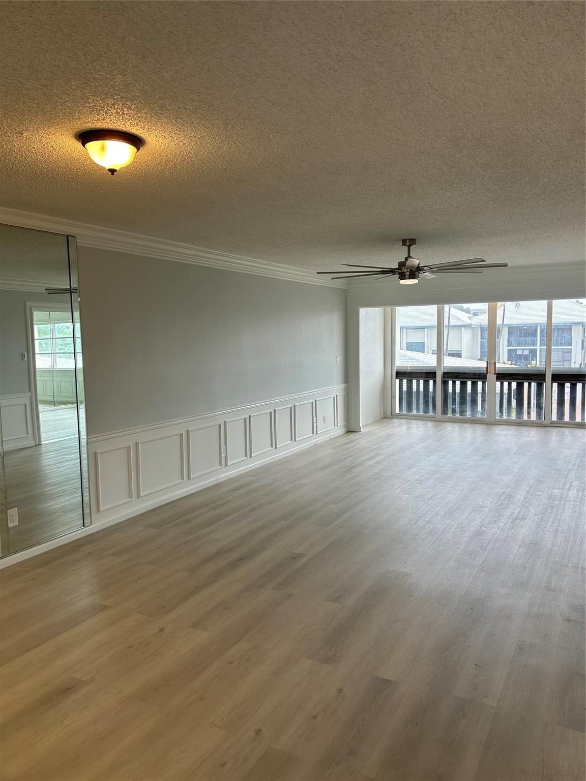 Living Room/ Family Room:Brand new flooring just installed. Custom moldings (wainscoting) / wood work throughout the unit. View from balcony/ patio/ sun room looks over the St. Lucie River, pier, club house, pool, and shuffle board.