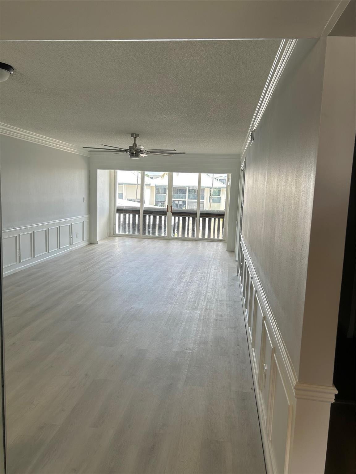 View of the Living/ Family Room/ Balcony and from the entrance of the condo. The 2nd bedroom/ guest bedroom, guest bathroom and storage is to the right of this entry way.