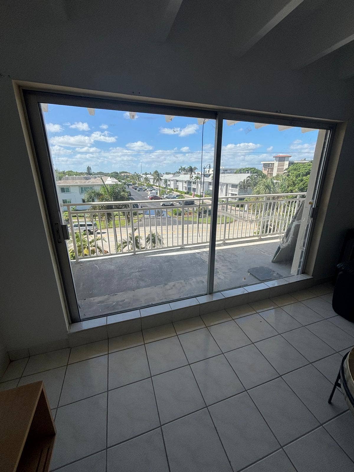 4500 S Ocean Boulevard, #310, South Palm Beach, FL 33480 Large sliding glass doors opening to a balcony with metal railings and white tile flooring