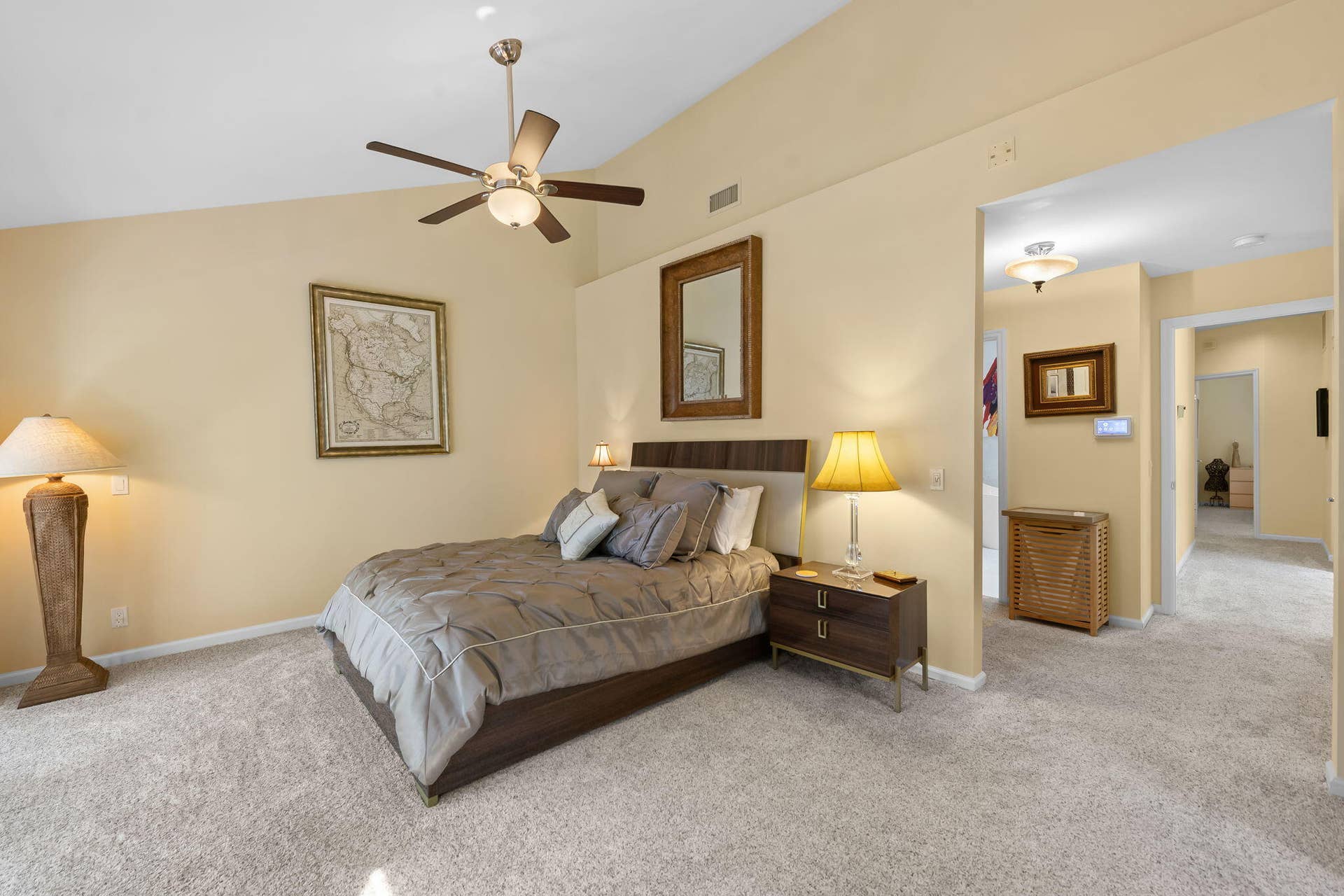 Vaulted ceilings featuring a central ceiling fan with integrated lighting